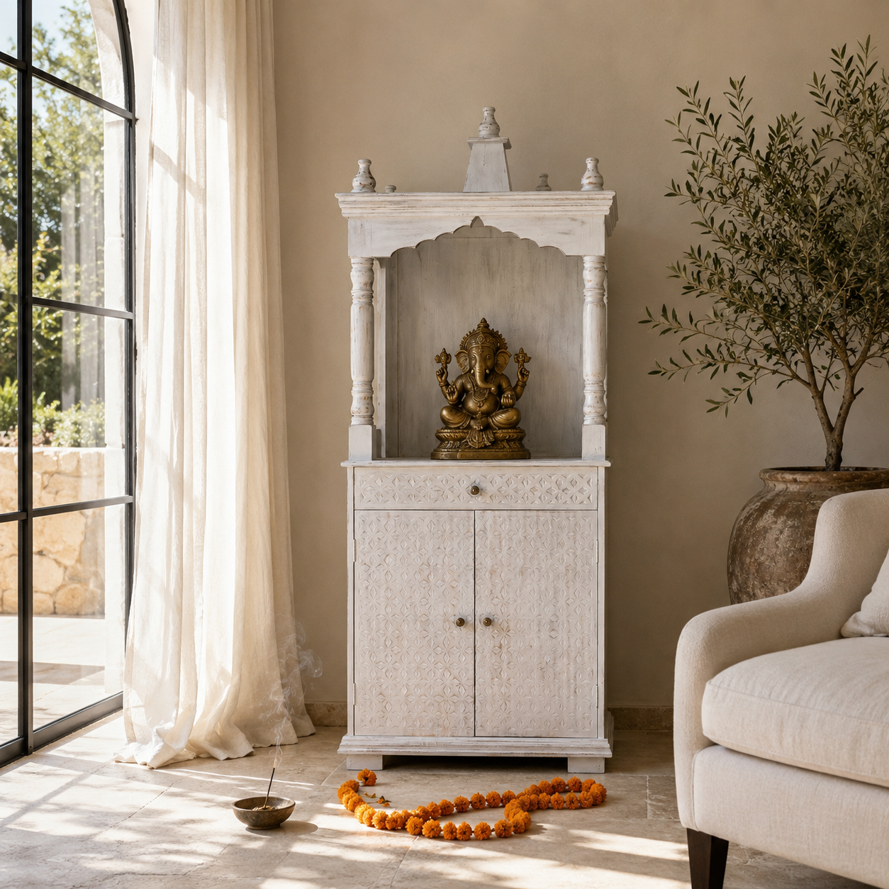 Lifestyle image of a mango wood house temple in whitewashed finish with carved floral doors and traditional arched canopy—an elegant example of hand-carved Mandirs and Indian home temples.