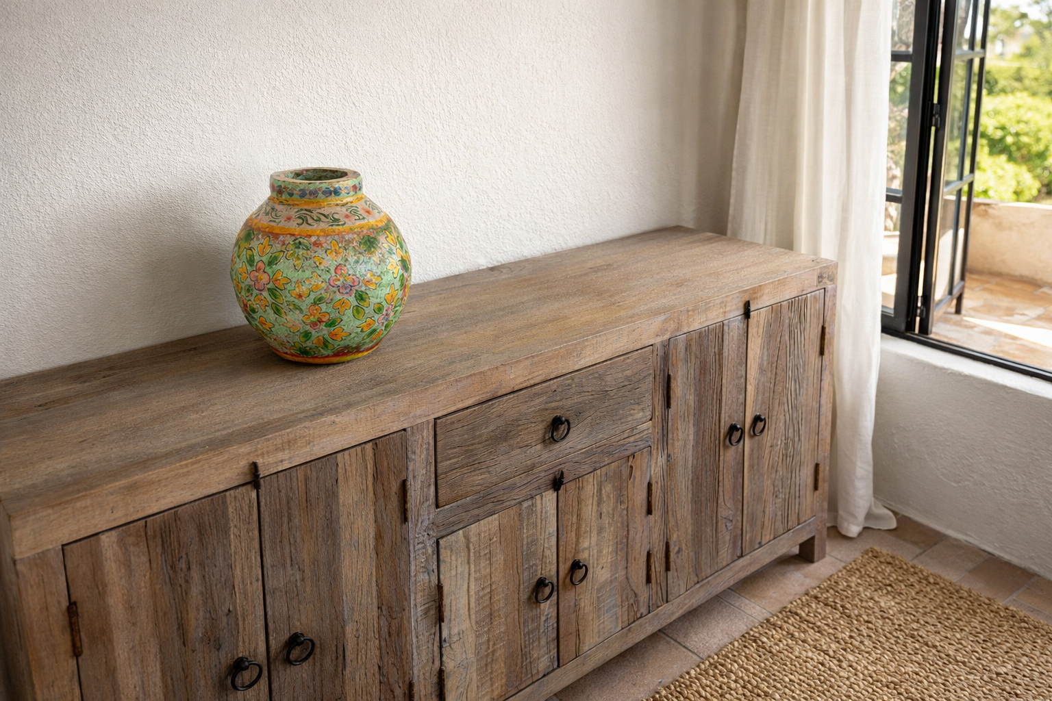 Lifestyle imagination of a of hand-painted papier-mâché vases from India with floral folk-art designs in vibrant mixed colours. Unique Indian decor and decorative art objects handcrafted using traditional methods.