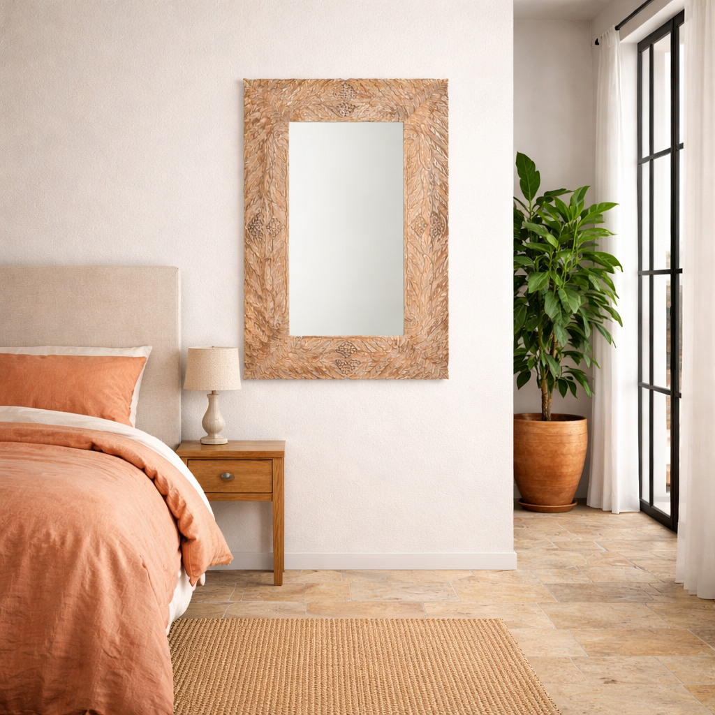 Lifestyle image of a of a carved mango wood mirror Anumati with floral motifs and distressed finish. A handcrafted Indian furniture piece perfect for vintage home decor and artisanal interiors.
