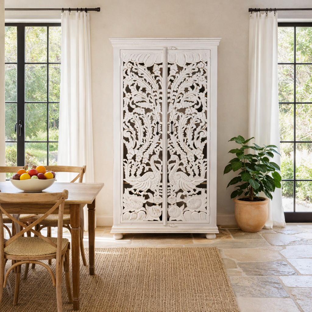 Lifestyle image of a hand-carved mango wood wardrobe with peacock and floral motifs, whitewashed finish; elegant wooden wardrobe and mango wood furniture, 190 × 100 × 40 cm.