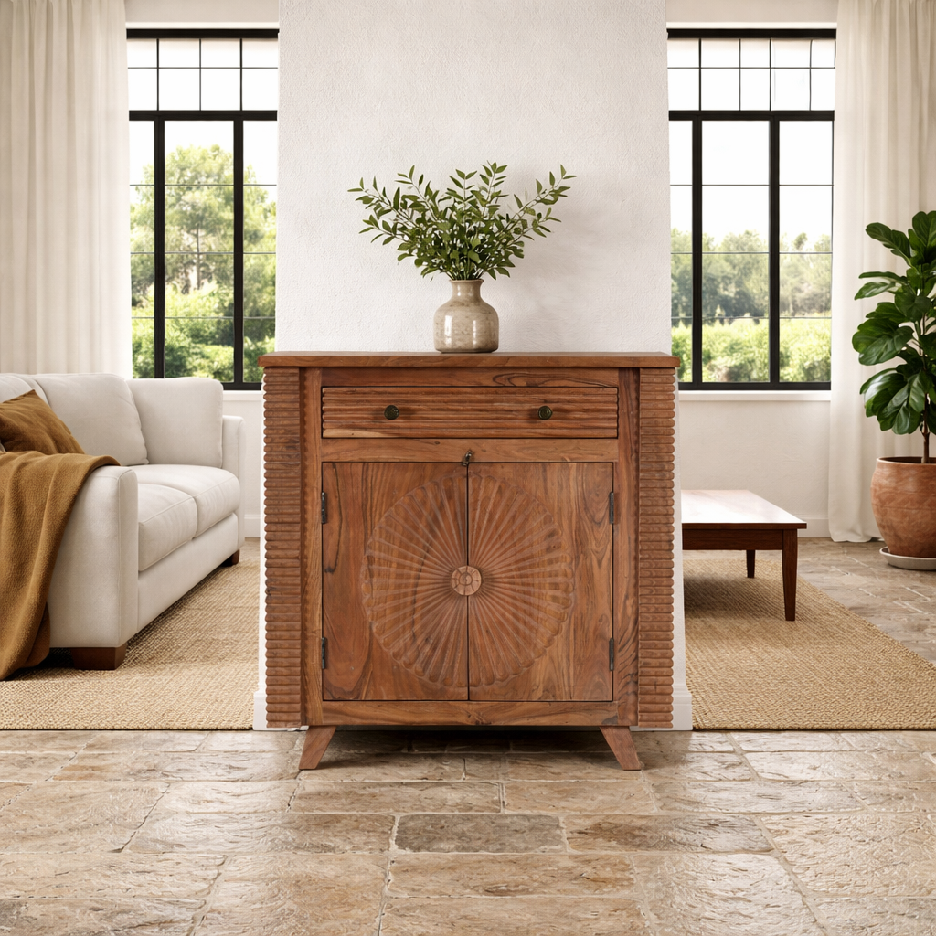 Lifestyle imagination of a acacia wood cabinet with hand-carved sunburst doors, grooved details, and one drawer, 90 × 40 × 90 cm.