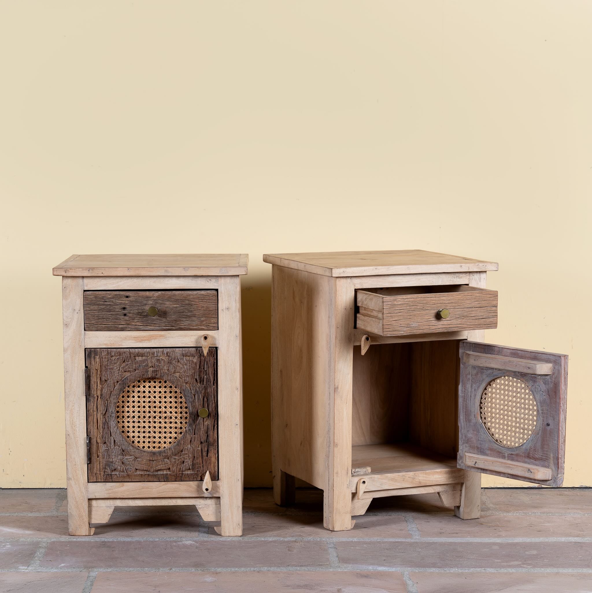 Side angle image with open doors of a Milan hand carved reclaimed wood nightstands with woven rattan inserts, drawer storage, cabinet doors, and warm natural boho style design.