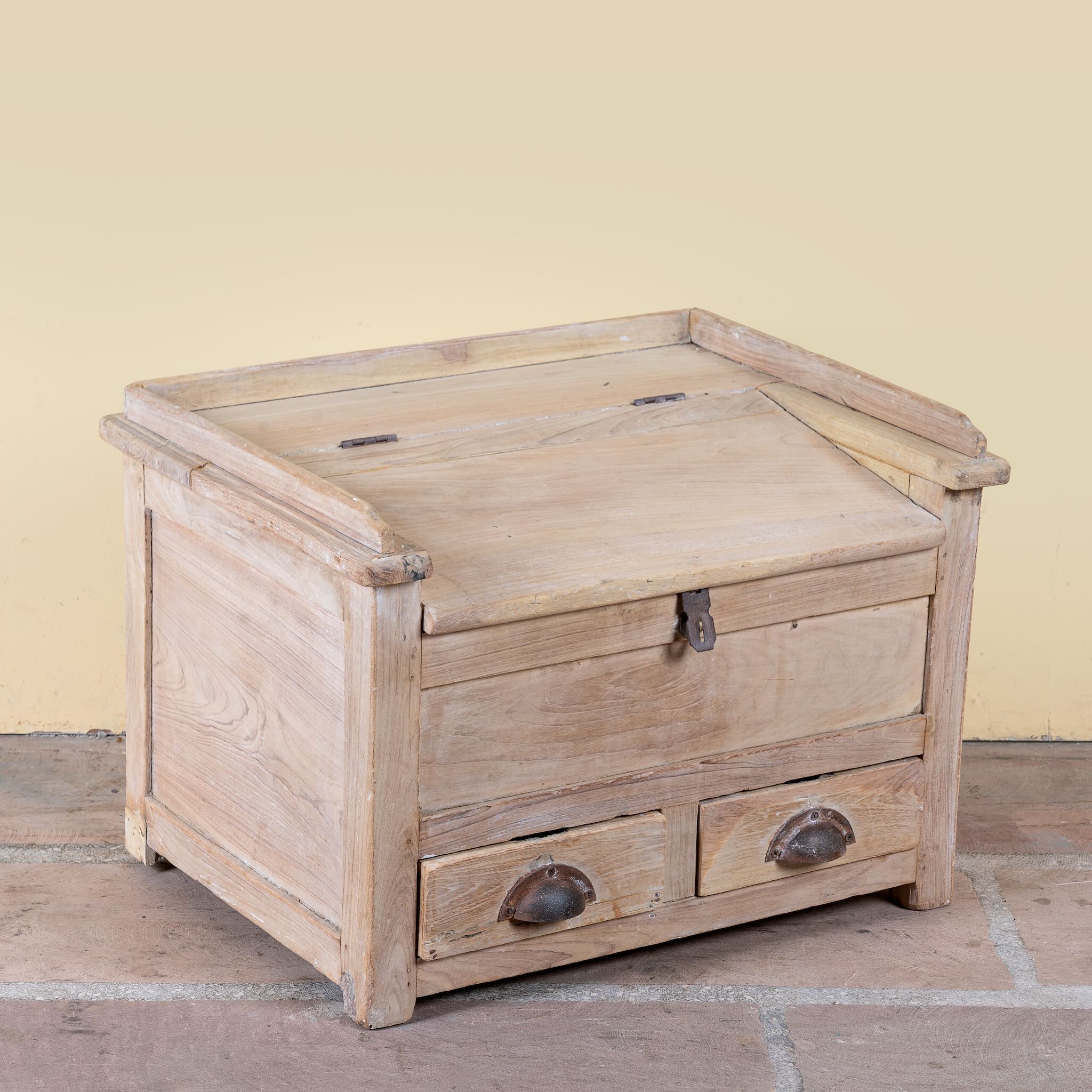 Side angle image of a Mivaan vintage reclaimed teak wood box with writing lid, small drawers, and restored rustic teak finish.