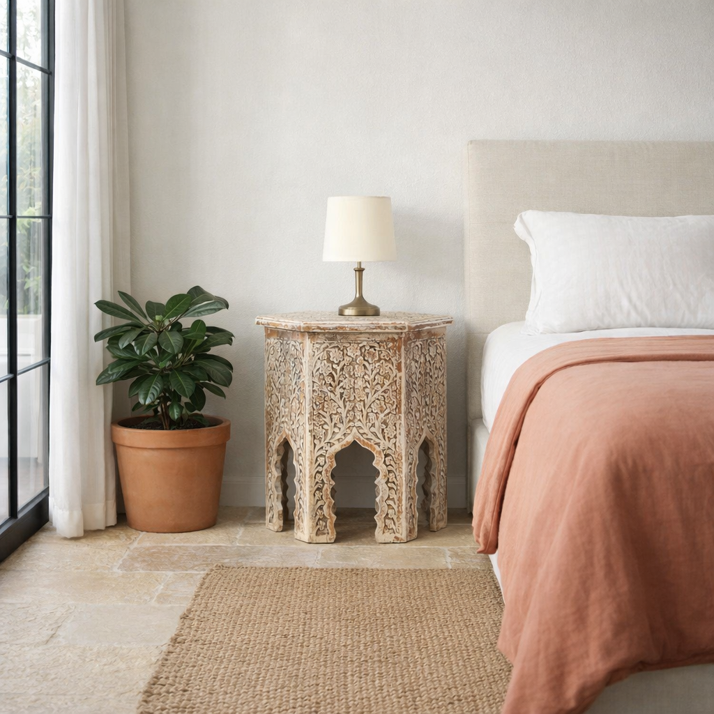 Lifestyle image of a Amreli antique white coffee table made of mango wood, hand carved.