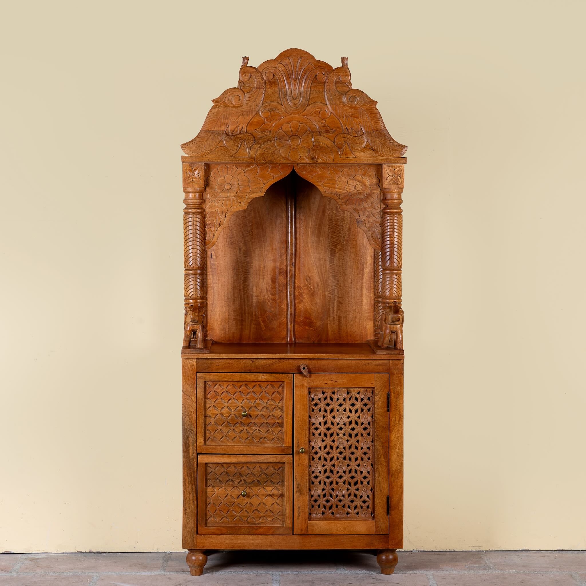 Moksha hand carved mango wood mandir with decorative Indian carvings, drawers, and cabinet storage.