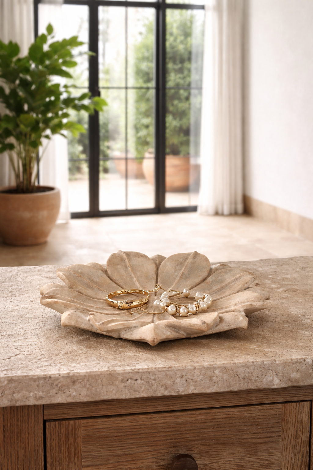 Lifestyle image of a of a hand-carved marble flower plate Arika with layered petal design. A vintage home accessory and unique Indian decoration, ideal as a soap dish, jewellery holder, or sweet tray in vintage home decor.