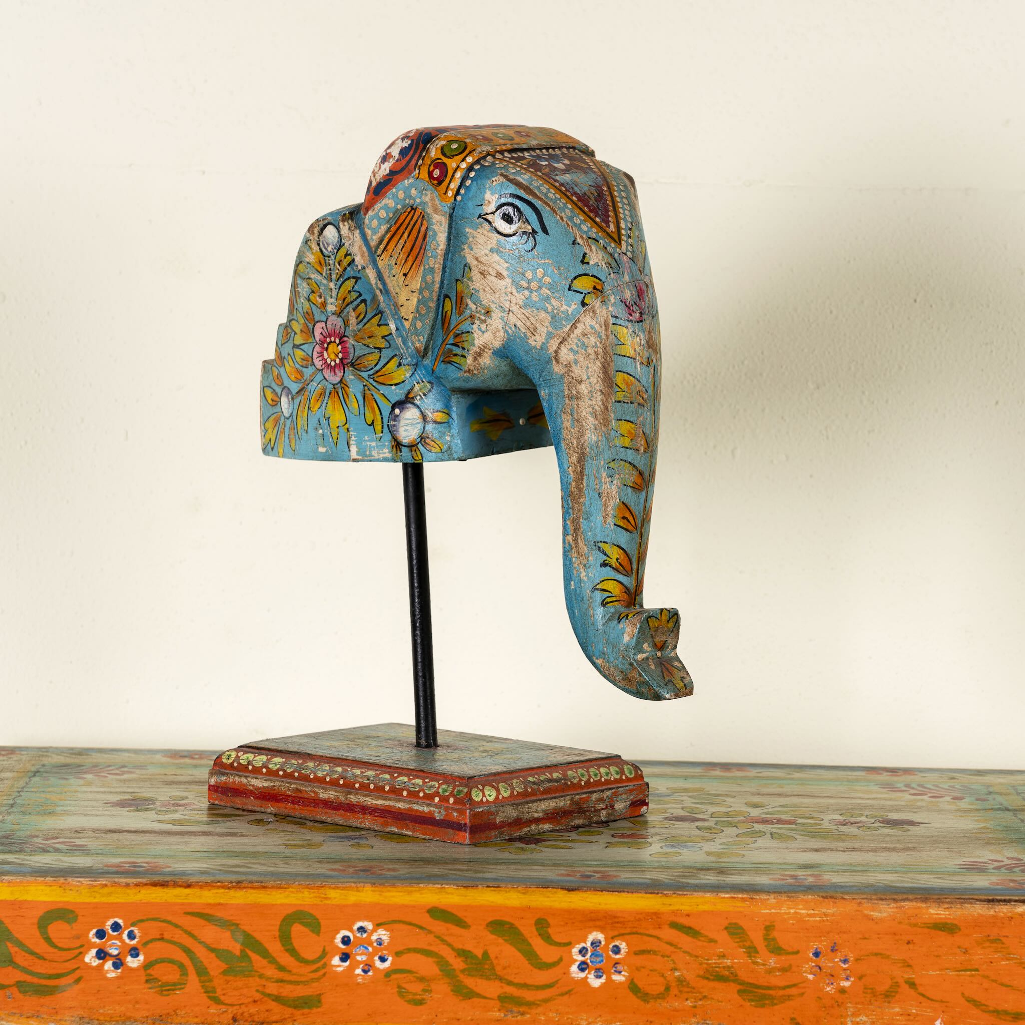 Hand-painted decorative wooden elephant head on iron stand with floral Indian folk art – ideal for Indian and vintage home accessories.