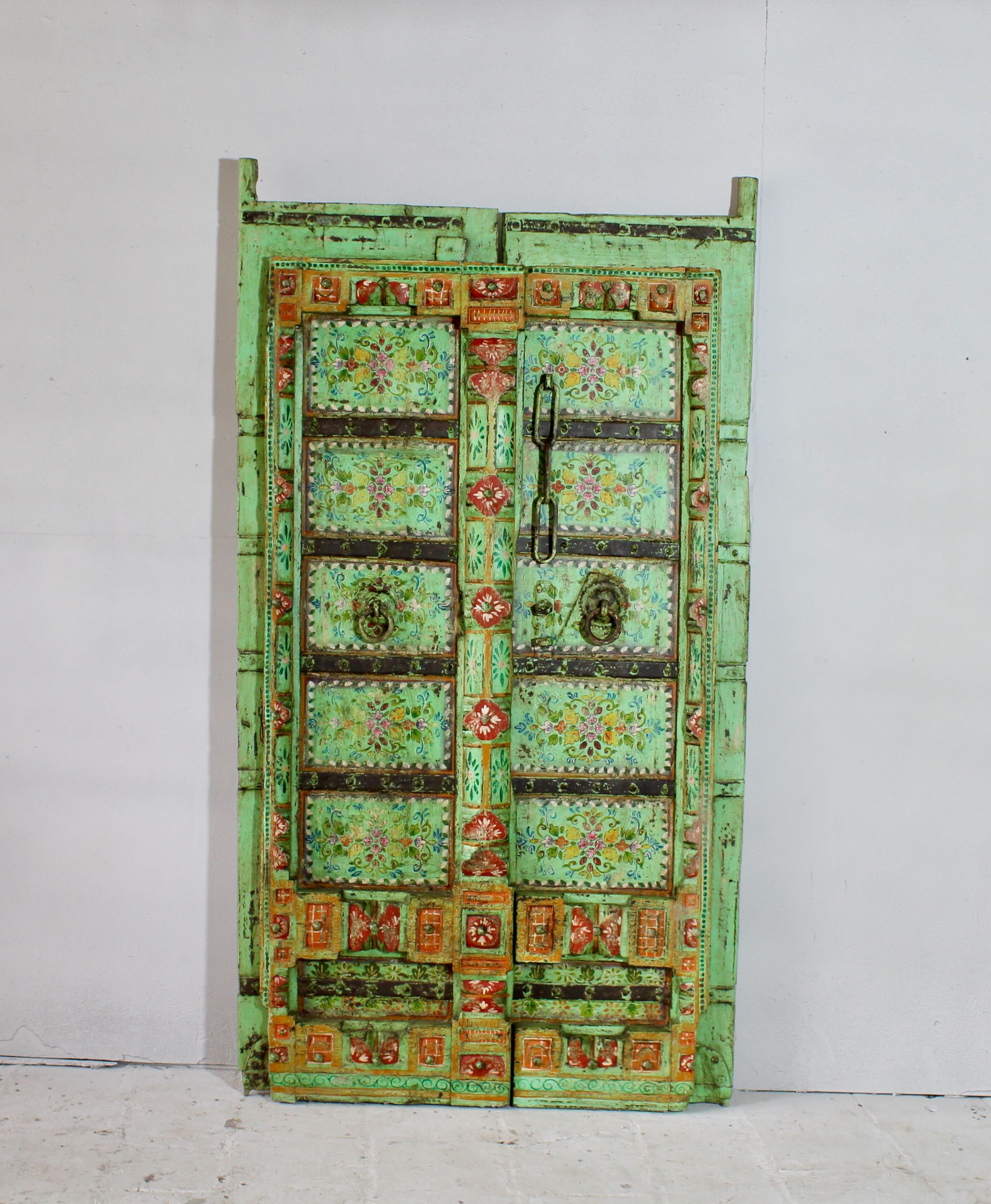 Antique Indian teak door hand-painted with floral and geometric motifs, distressed mint-green frame, vintage wall panels and vintage home decor.