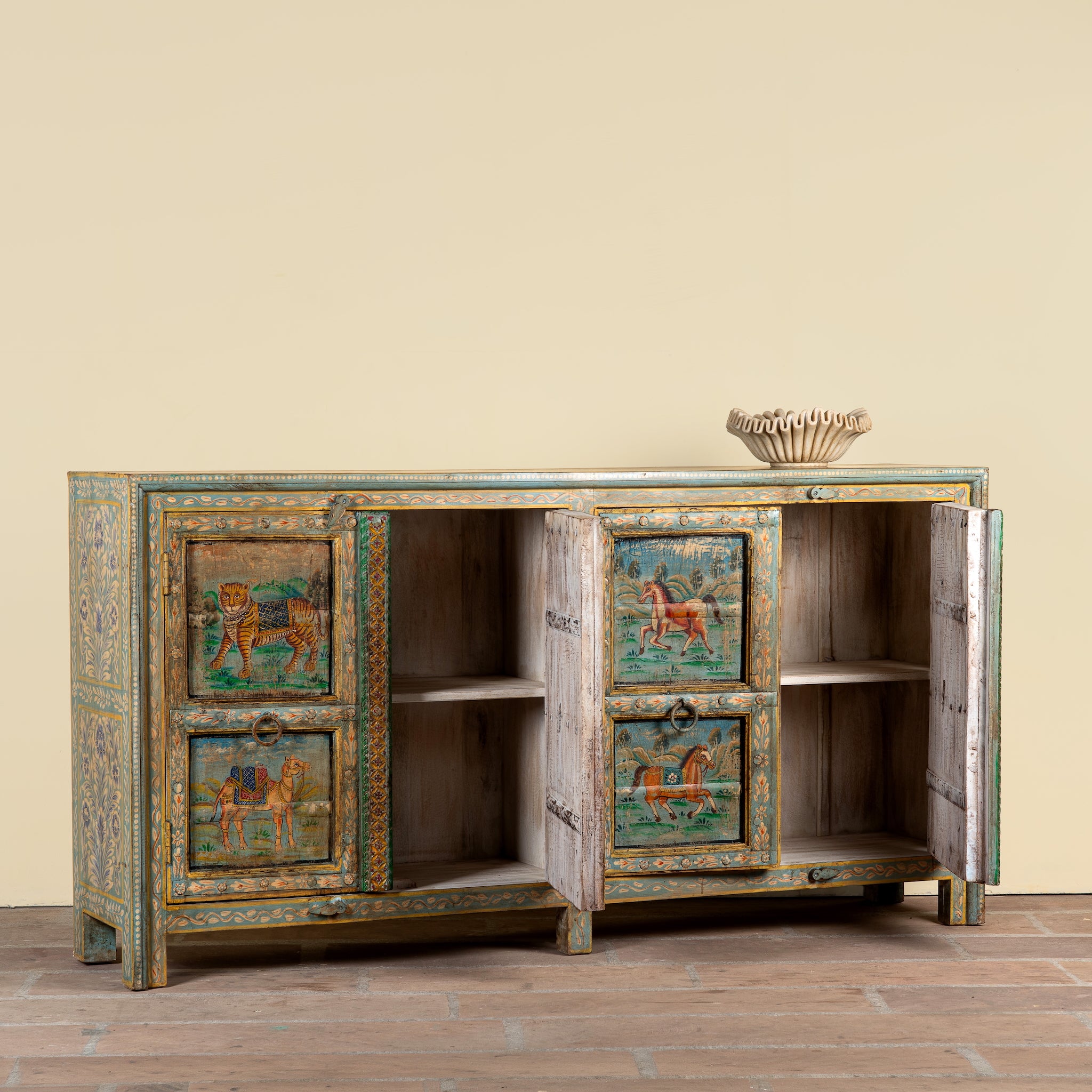 Side angle image showing open doors of a Pavan hand-painted reclaimed wood sideboard with original Indian teak doors and colourful tiger, camel, elephant, horse and lion motifs 193cm