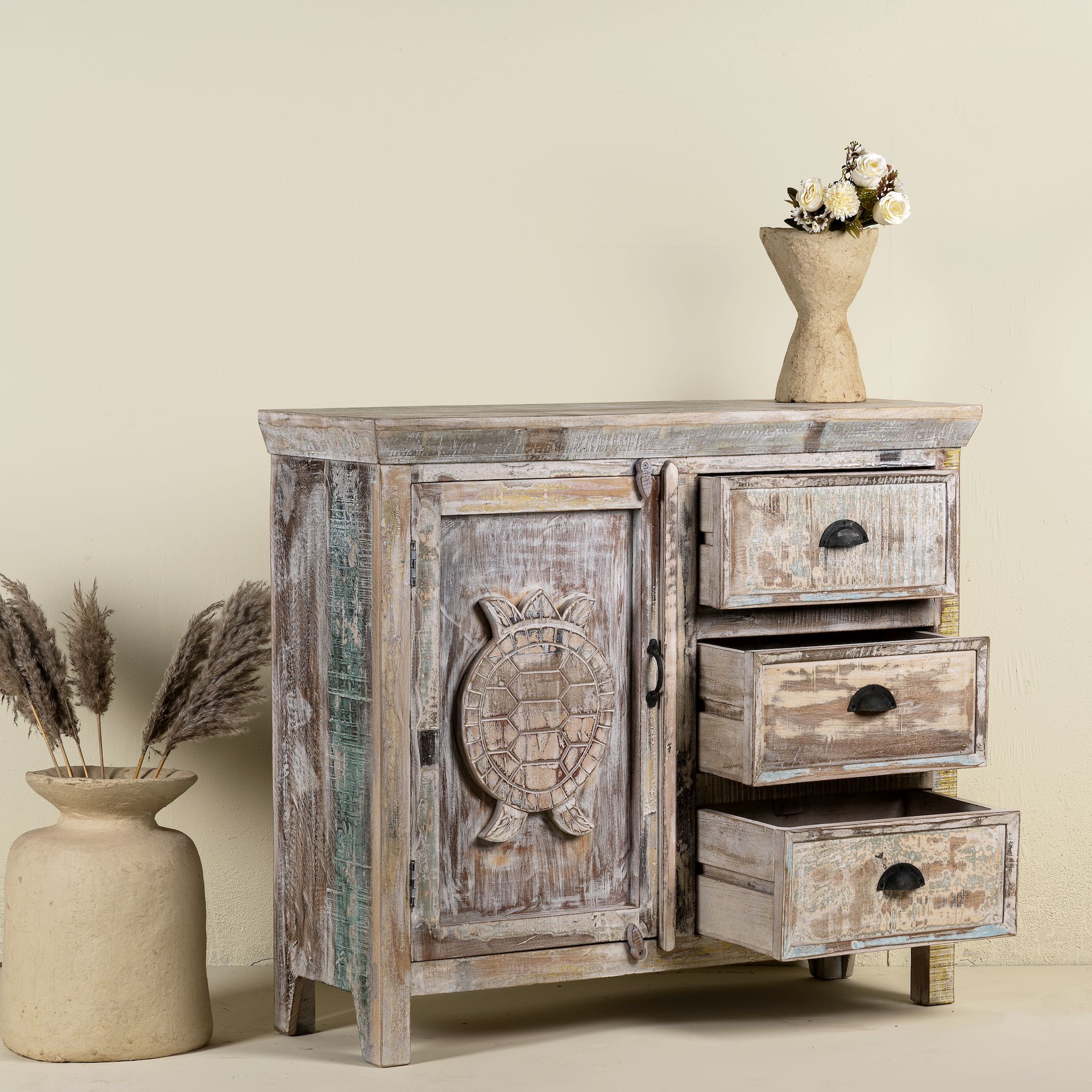 Open drawer image of a handcrafted cupboard made from reclaimed wood with a carved turtle motif and pastel finish; vintage furniture and sustainable furniture, 110 × 96 × 40 cm.