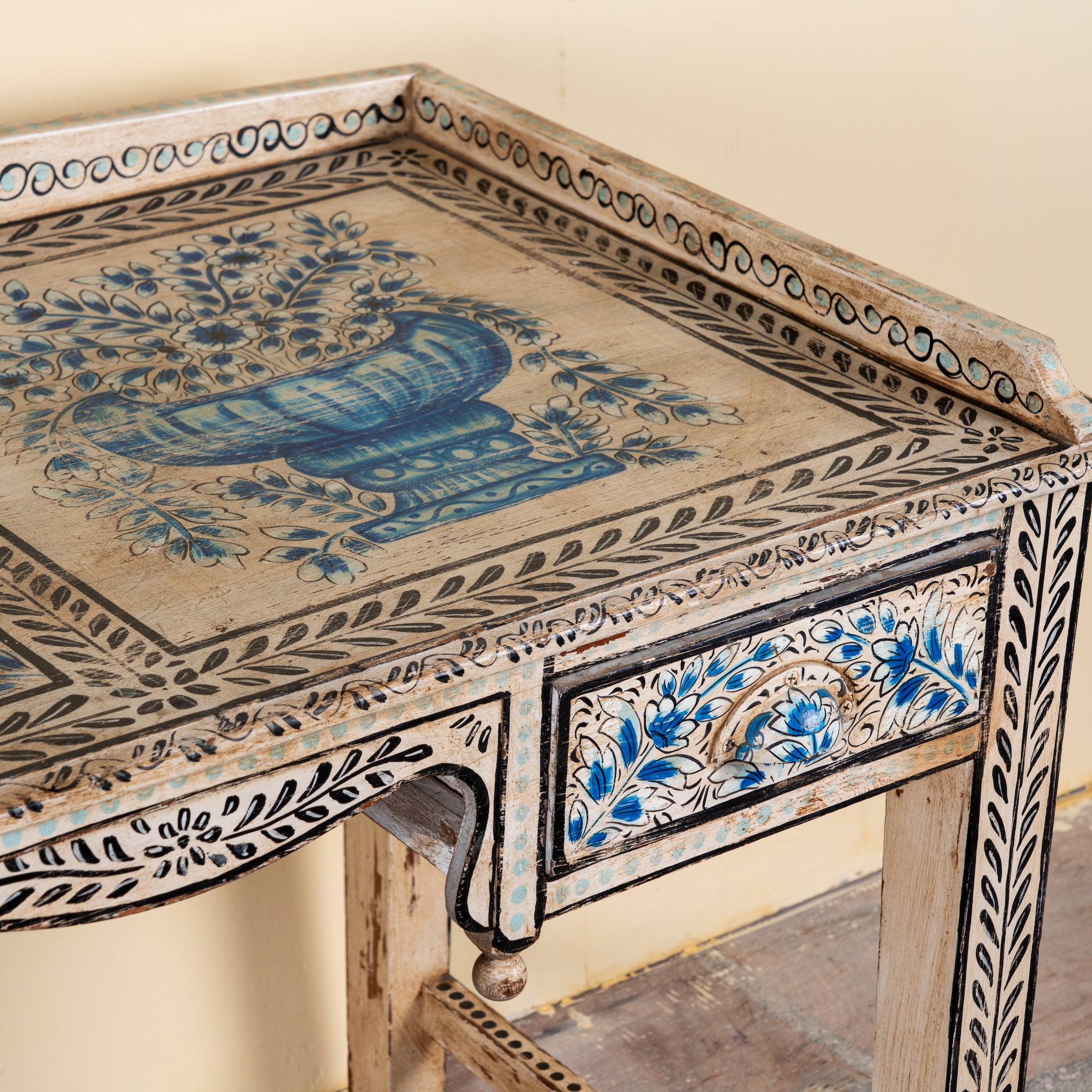 Close up image of a Pranay hand painted reclaimed wood desk with blue and white floral motifs and two drawers 114cm