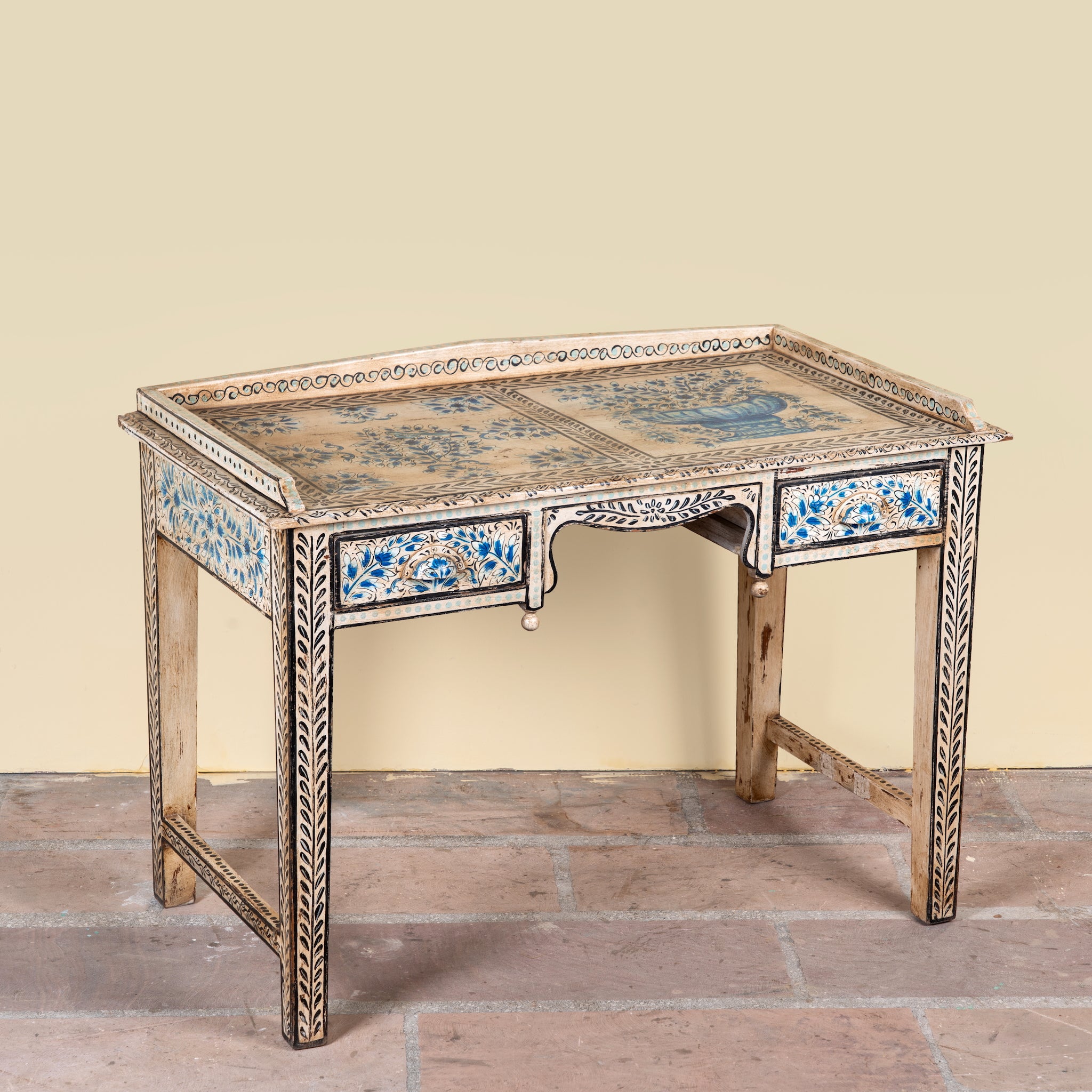 Side angle image of a Pranay hand painted reclaimed wood desk with blue and white floral motifs and two drawers 114cm