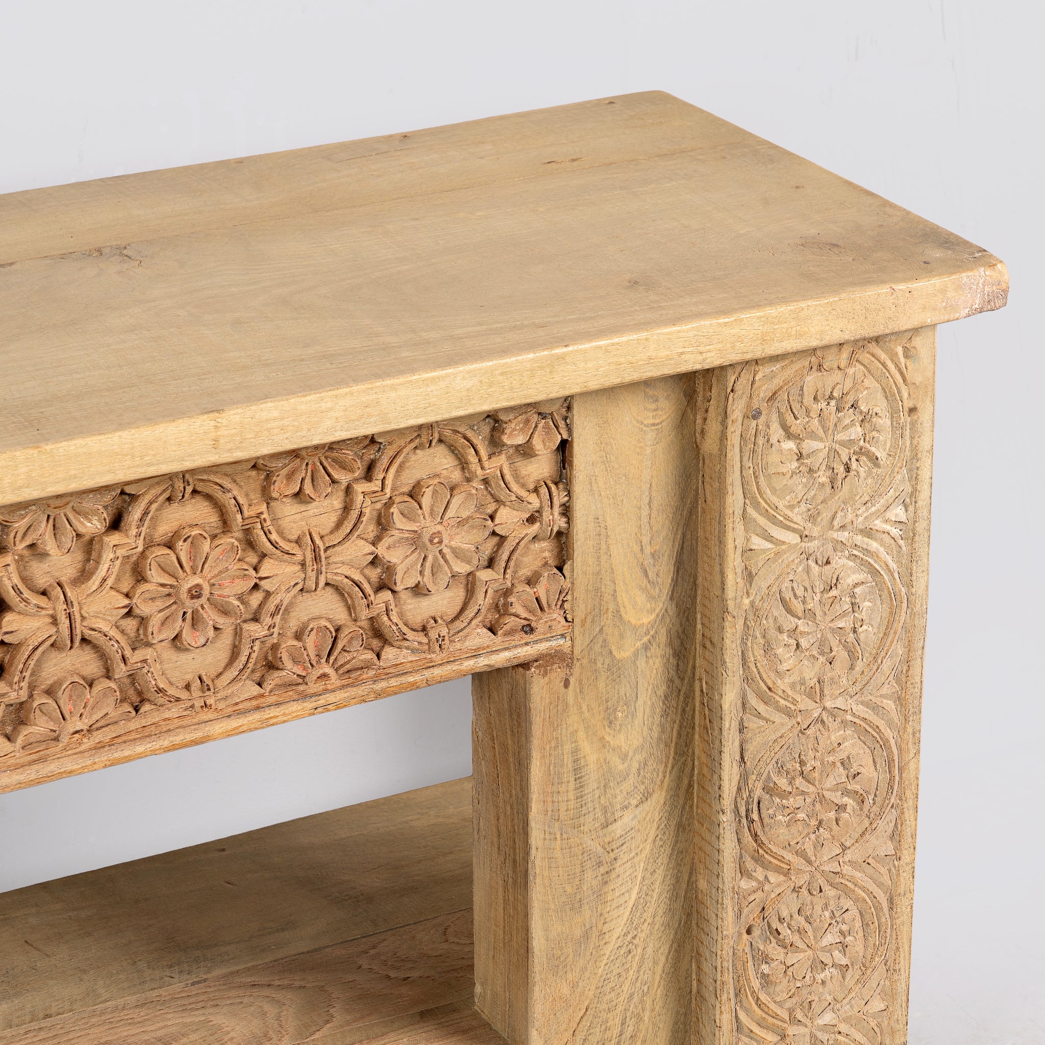 Close up image of a Purna reclaimed teak wood bench with hand carved Indian house elements and lower shelf 160cm