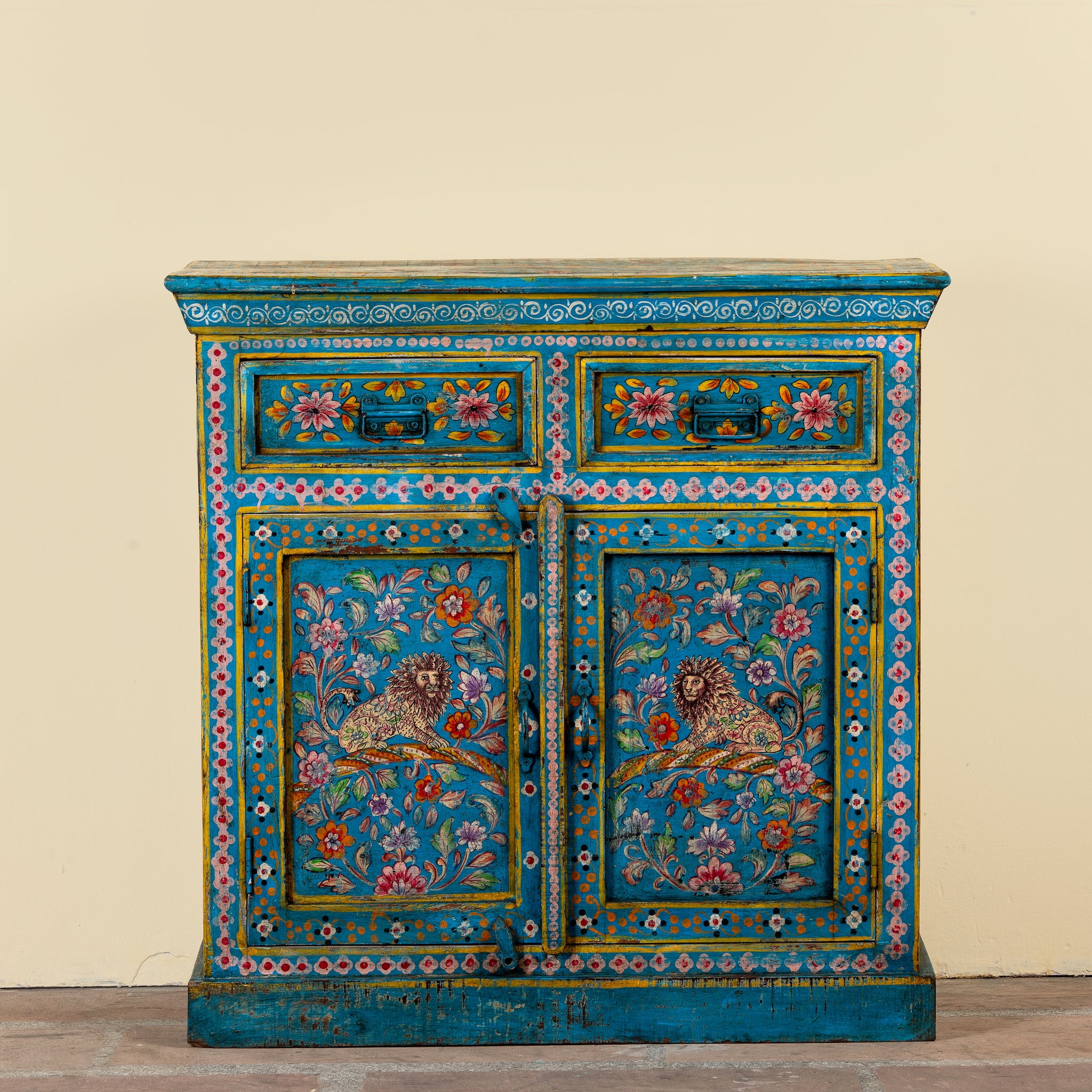 Rajat hand-painted blue reclaimed wood cabinet with colourful floral and animal motifs, two drawers and two doors.