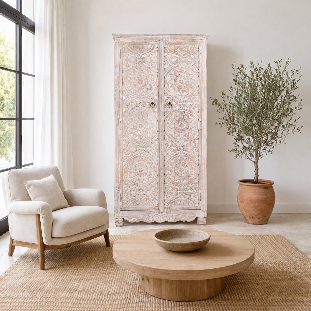 Life style image of a hand-carved mango wood wardrobe with whitewashed finish; wooden wardrobe perfect for living room furniture or bedroom storage, 180 × 90 × 40 cm.