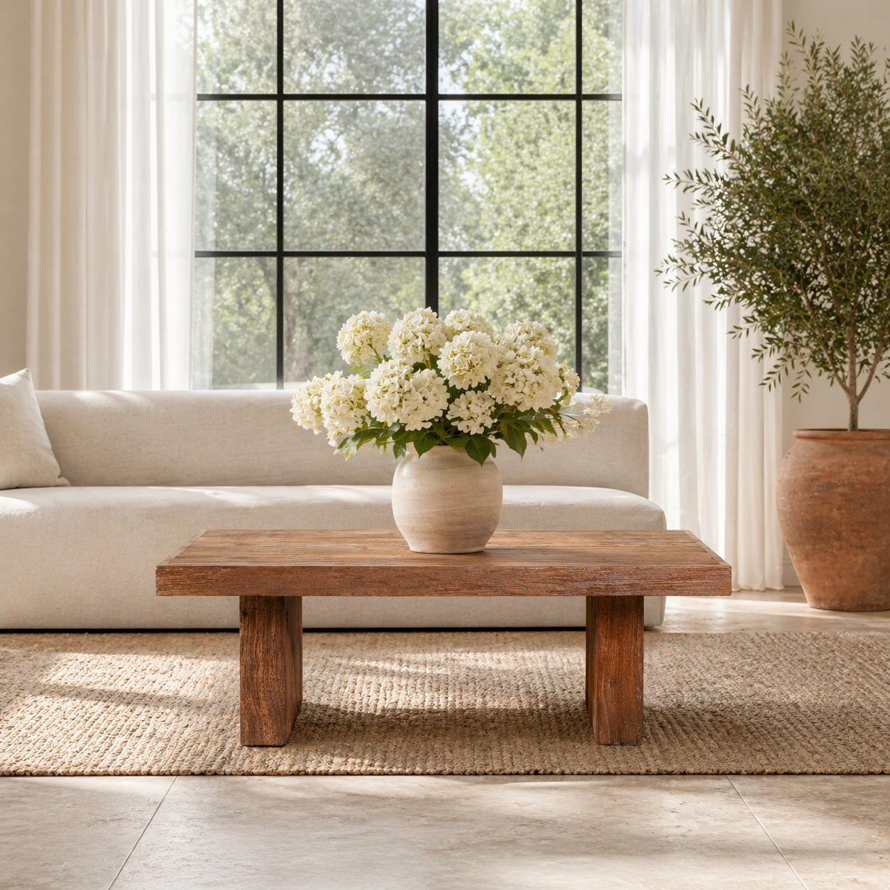 Lifestyle image of a rectangular reclaimed wood coffee table with block legs; sustainable furniture for rustic and modern interiors, 120 × 80 × 46 cm.