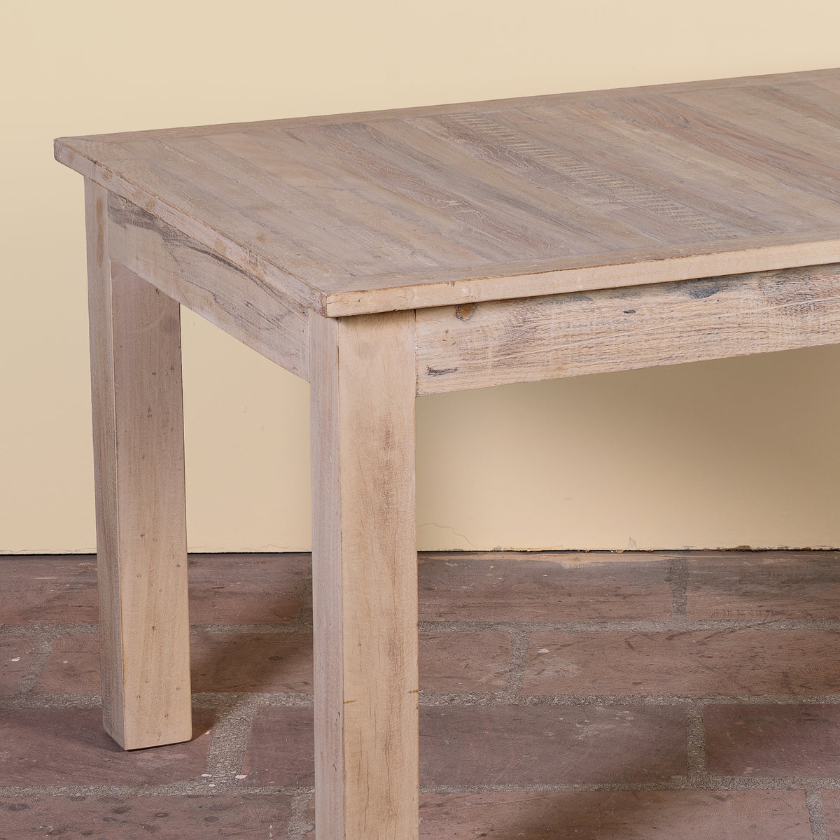 Close up image of a Ravi bleached reclaimed wood dining table with rectangular top and straight wooden legs, 150x90x76cm
