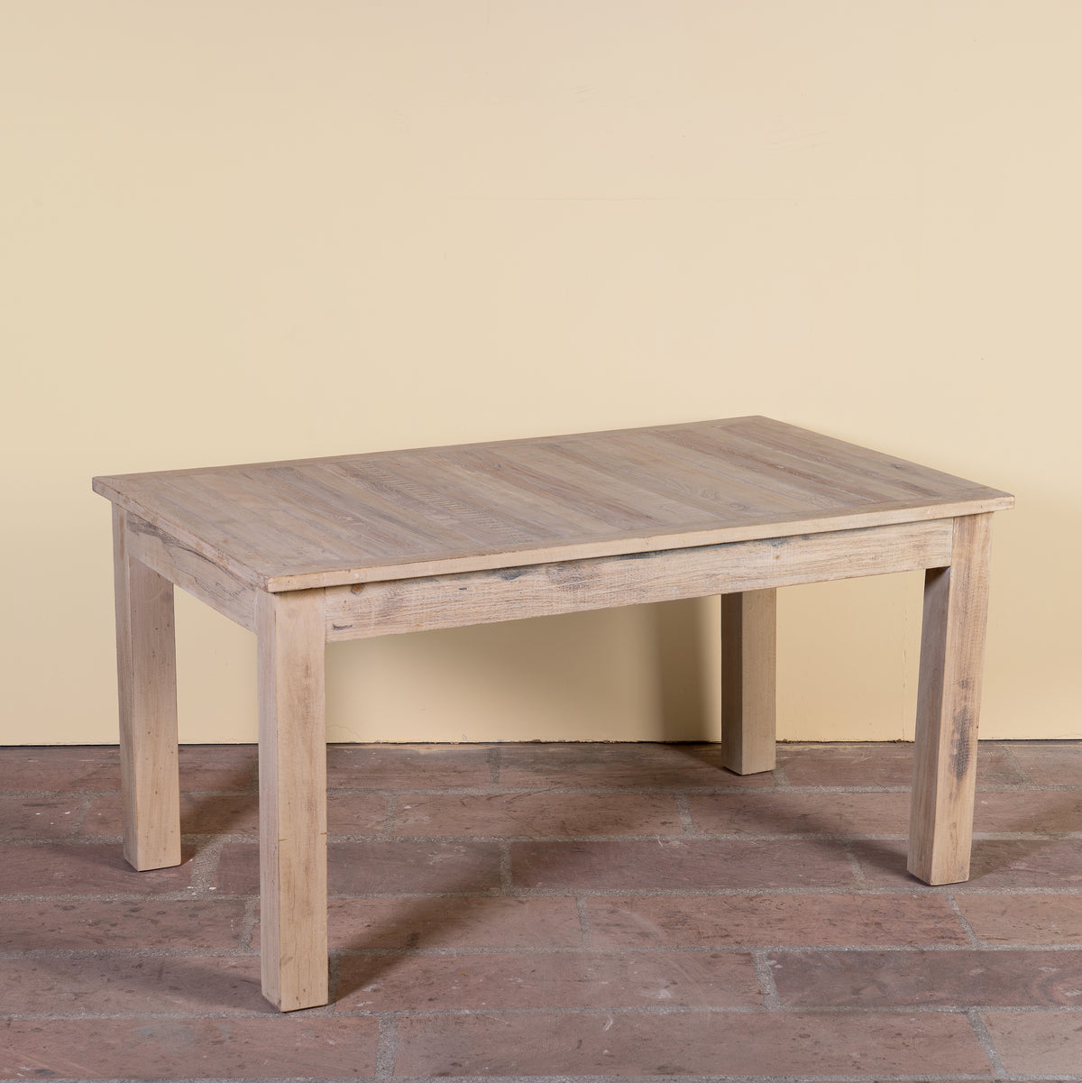 Side angle image of a Ravi bleached reclaimed wood dining table with rectangular top and straight wooden legs, 150x90x76cm