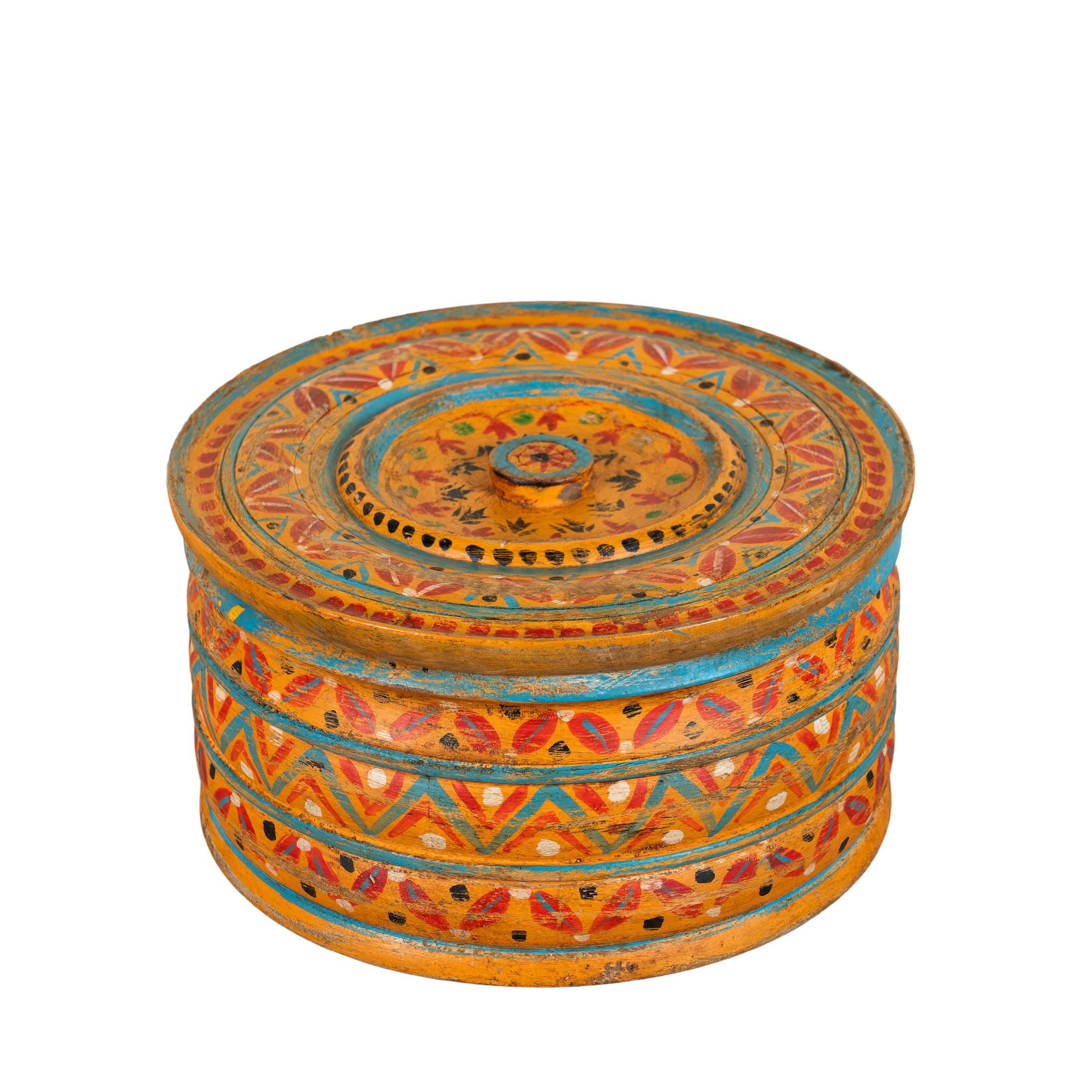White background image of a hand-painted round wooden box with lid, featuring traditional Indian script and decorative motifs in red, blue, and black. A unique Indian decor item used for storage or display, available in four different designs.