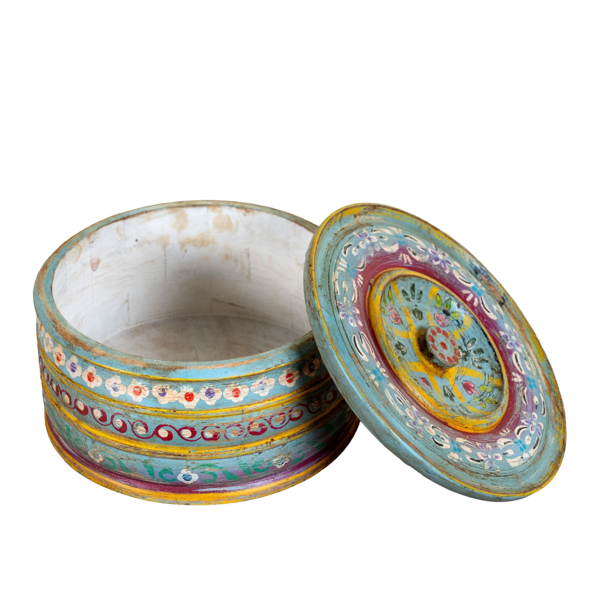 Hand-painted round wooden box with lid, featuring traditional Indian script and decorative motifs in red, blue, and black. A unique Indian decor item used for storage or display, available in four different designs.