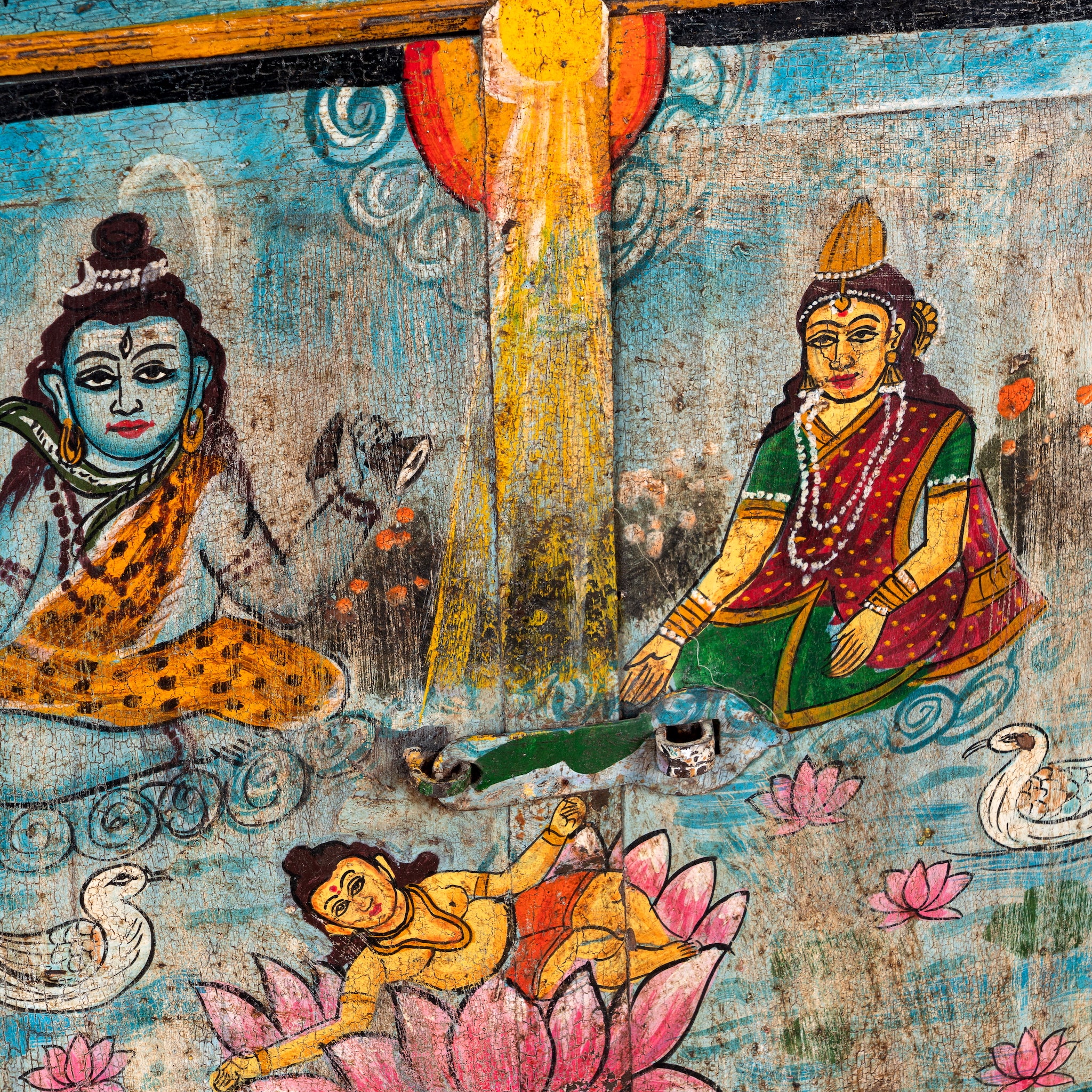 Close up image of a sacred Lotus antique reclaimed wood mirror with hand-painted Hindu artwork on an authentic reclaimed vintage wooden mirror frame, 50x50x5cm.
