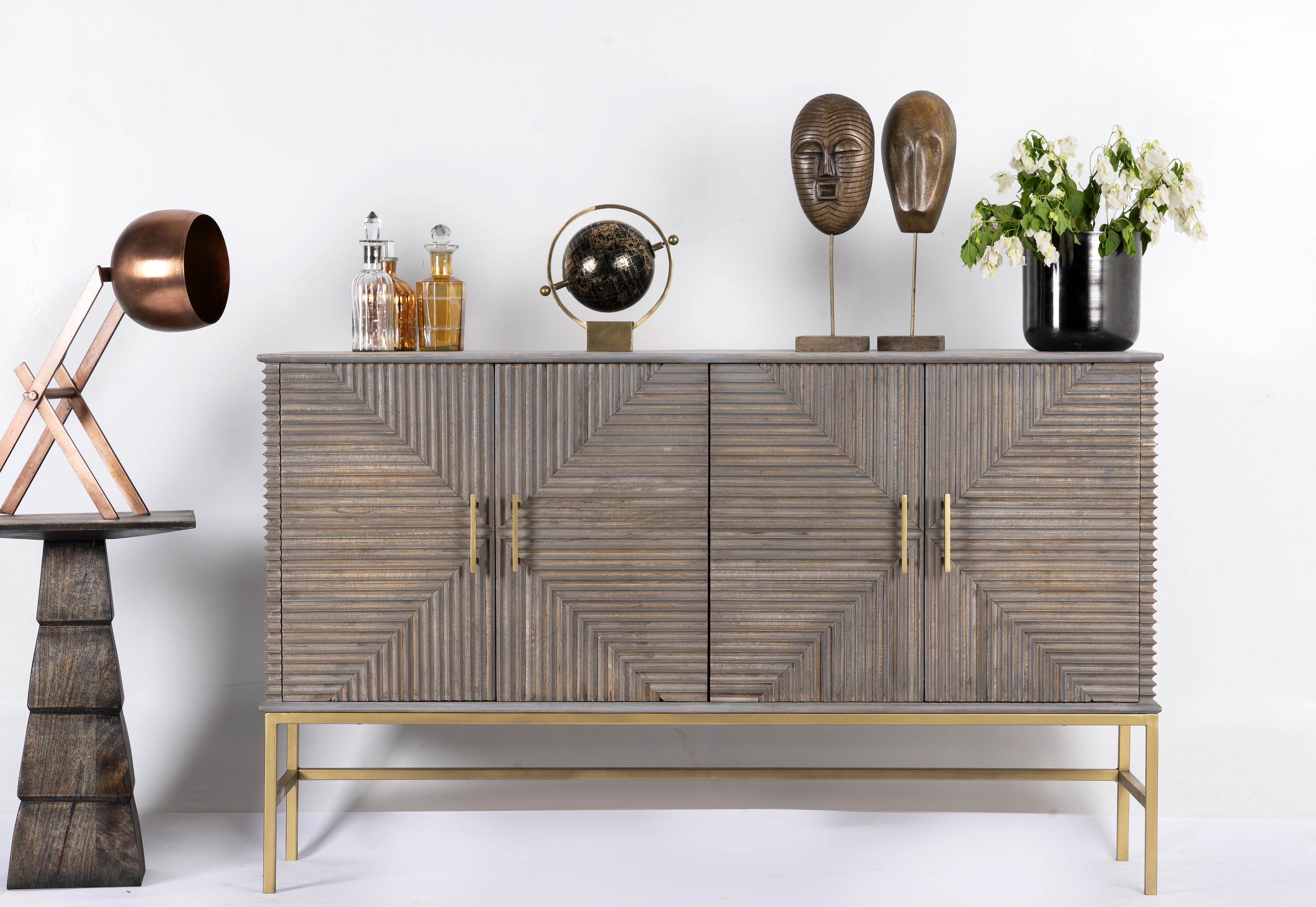 Artisanal wood carved sideboard in grey wash with contemporary brass base