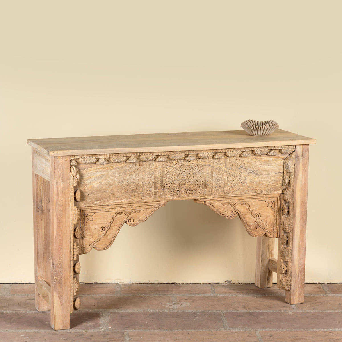 Side angle image of a Saiyan reclaimed teak wood console table with hand-carved old Indian house elements and architectural front 140cm