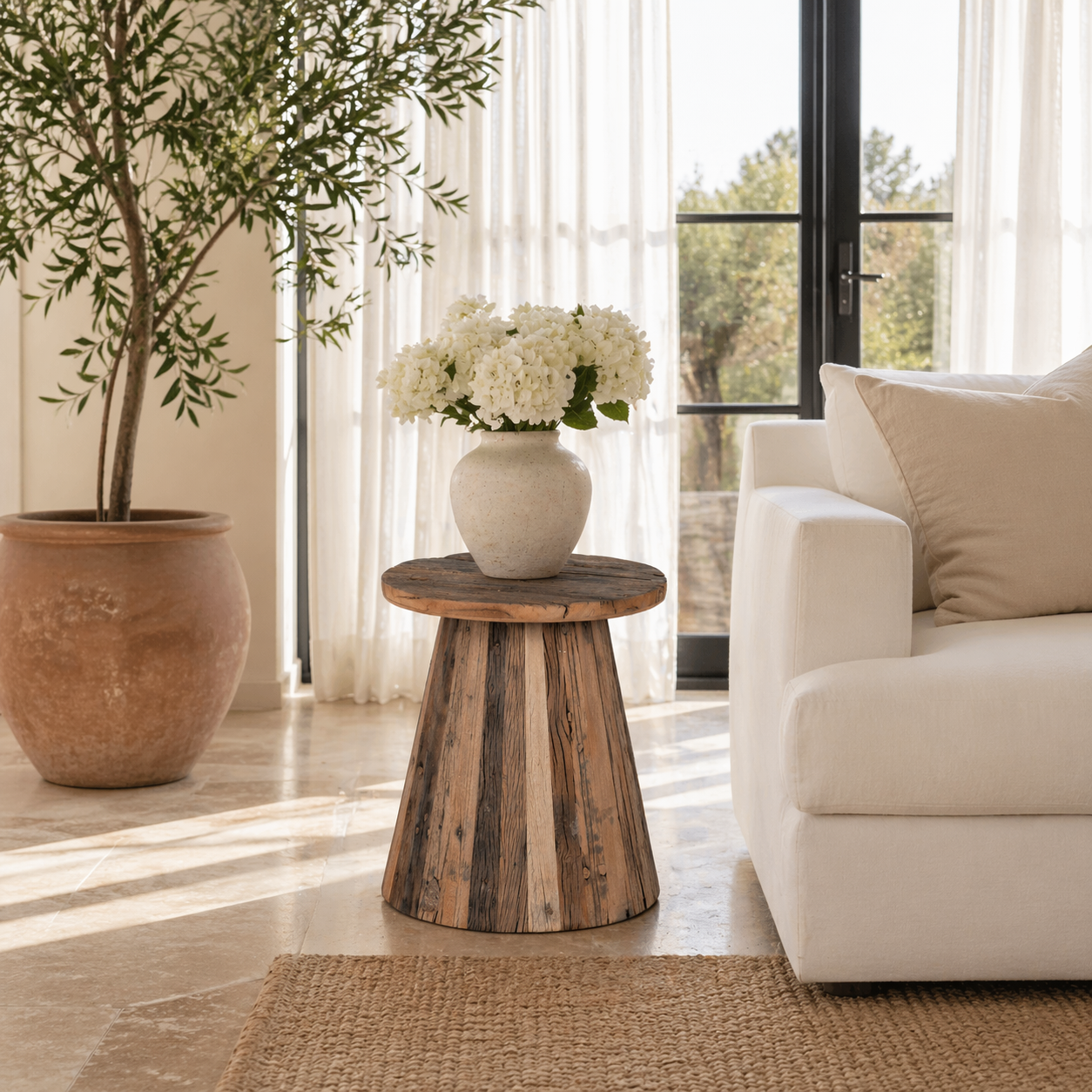 Lifestyle image of a sustainable driftwood coffee table with conical base, handcrafted from reclaimed wood with rustic minimalism, 45 × 54 cm.