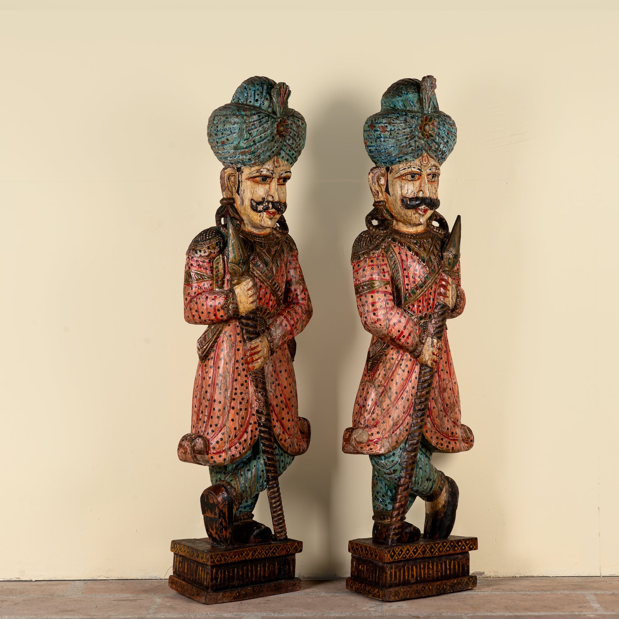 Side angle image of a Satyajit hand carved and hand painted reclaimed wood Rajasthani palace guard statues in traditional dress 153cm