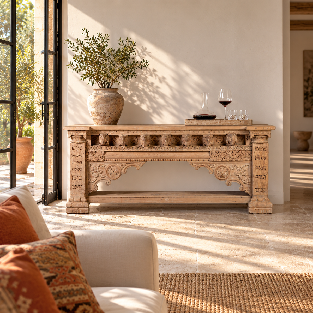 Lifestyle image of a Sayon large carved reclaimed teak console table with antique Indian house elements and lower shelf, 216x54x92cm