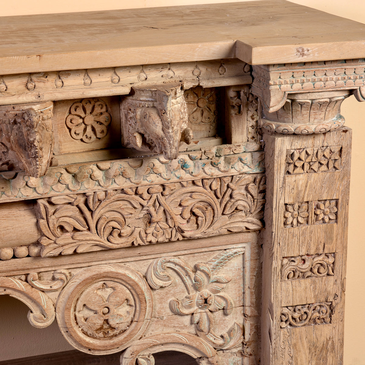 Close up image of a Sayon large carved reclaimed teak console table with antique Indian house elements and lower shelf, 216x54x92cm