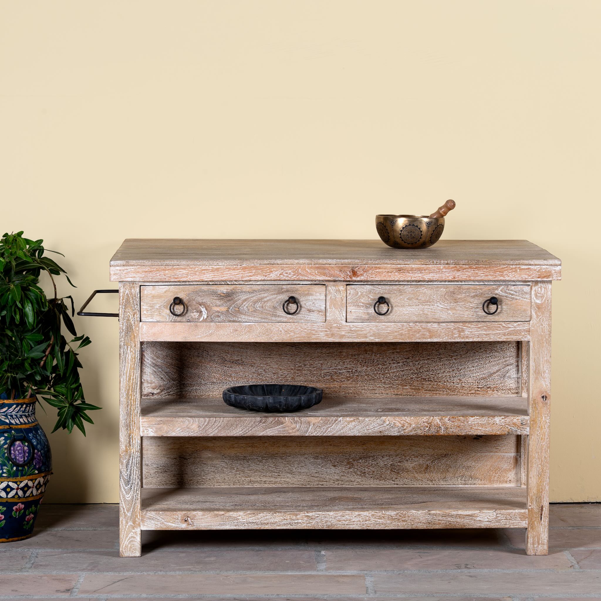 Image of a white washed mango wood console table with 4 drawers and shelves. Solid wood counter table with rustic vintage look and storage.