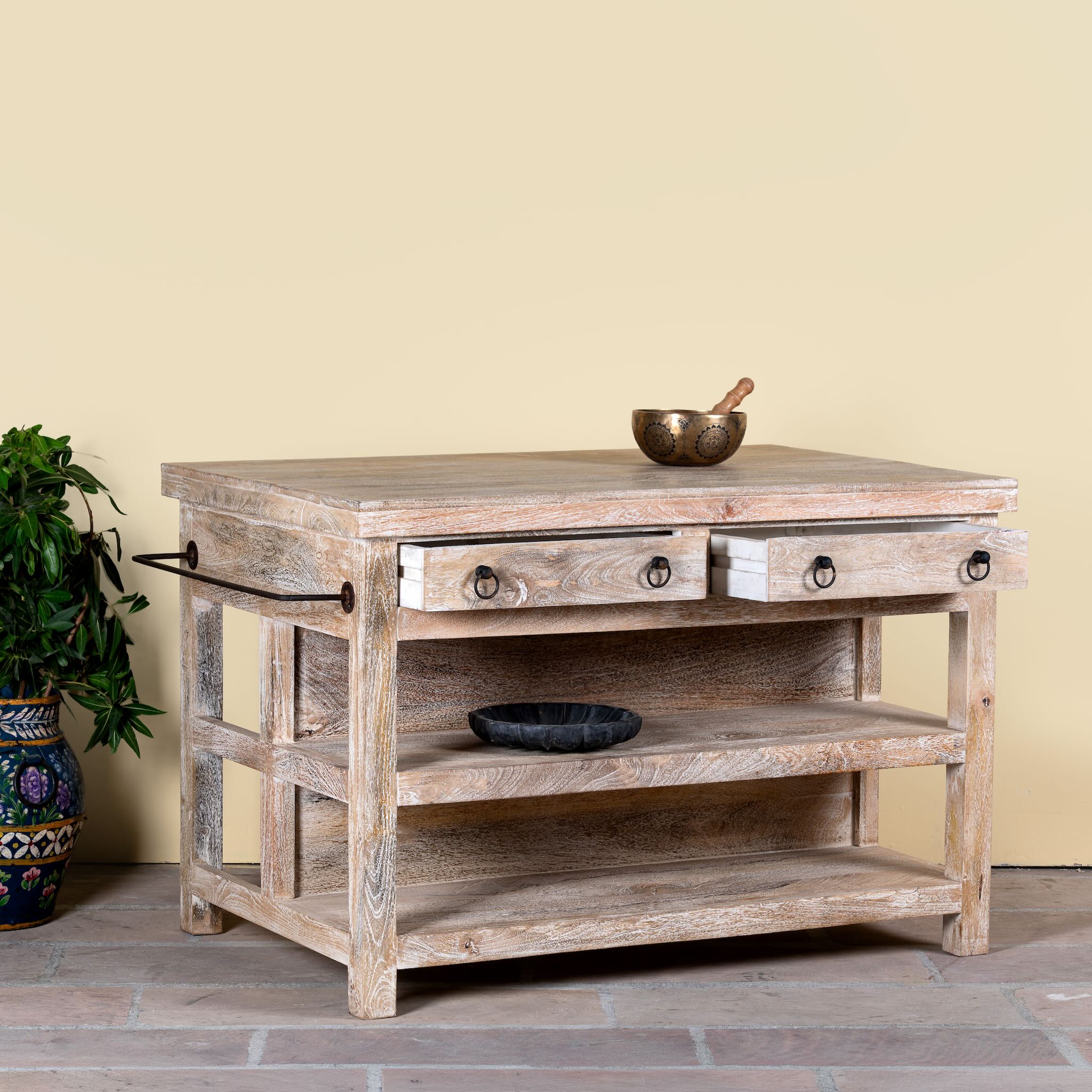 Wooden side table with two drawers and a shelf against a yellow wall.