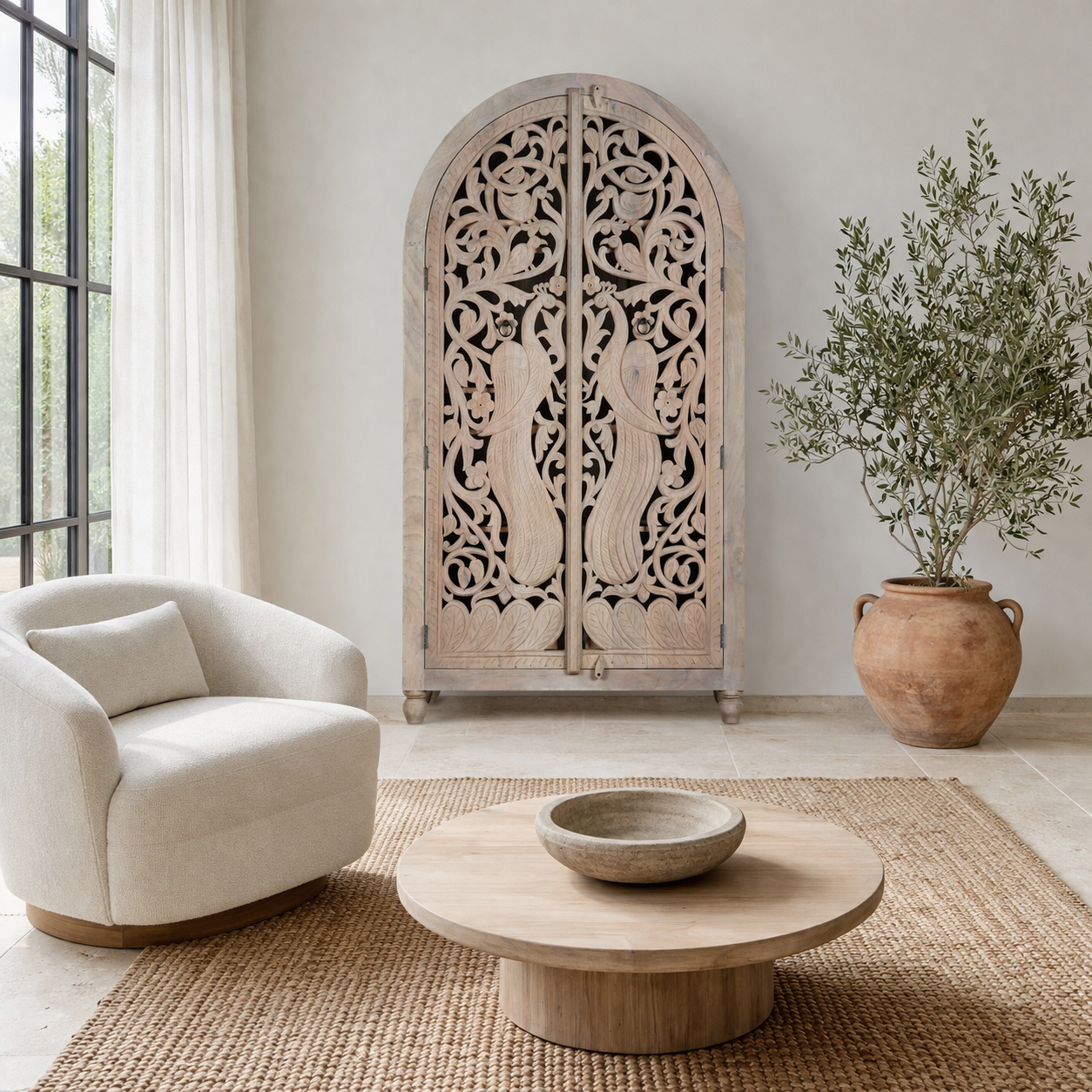 Lifestyle image of a hand-carved mango wood wardrobe with arched top and intricate peacock floral design – artisanal Indian bedroom furniture.