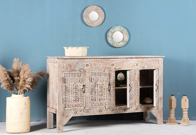 Side angle image with open door of a hand-carved mango wood sideboard with a three-layer vintage finish, featuring two doors and three drawers—perfect for rustic or bohemian interiors.