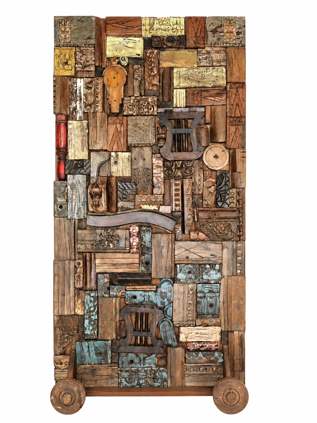 Reclaimed teak wood partition on wheels made from old doors, windows, and furniture pieces, with warm brown tones and colourful details.