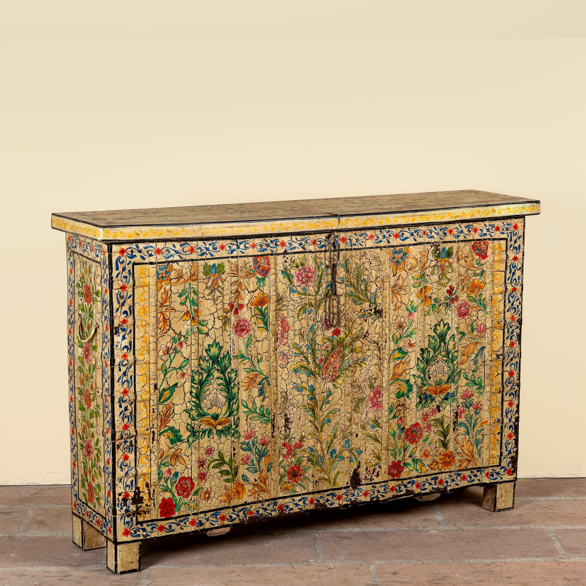 Side angle image of a Soham hand painted reclaimed teak wood storage box with colourful floral and botanical motifs 141cm
