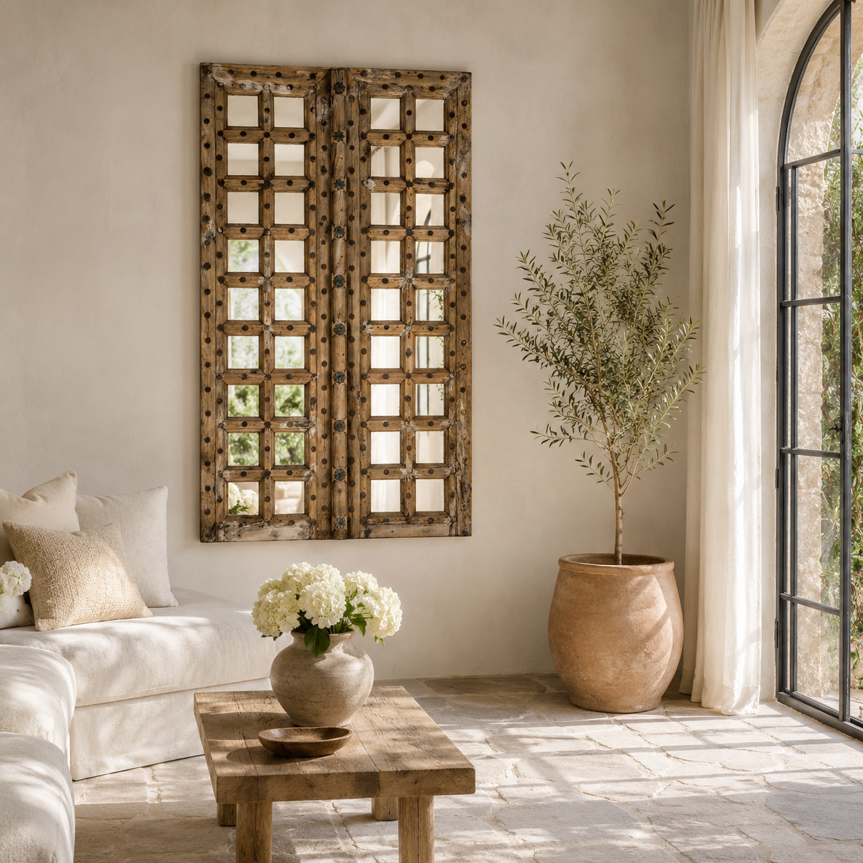 Lifestyle image of a wooden door mirror made from antique teak, part of our Indian home decor collection with original carvings and iron accents.