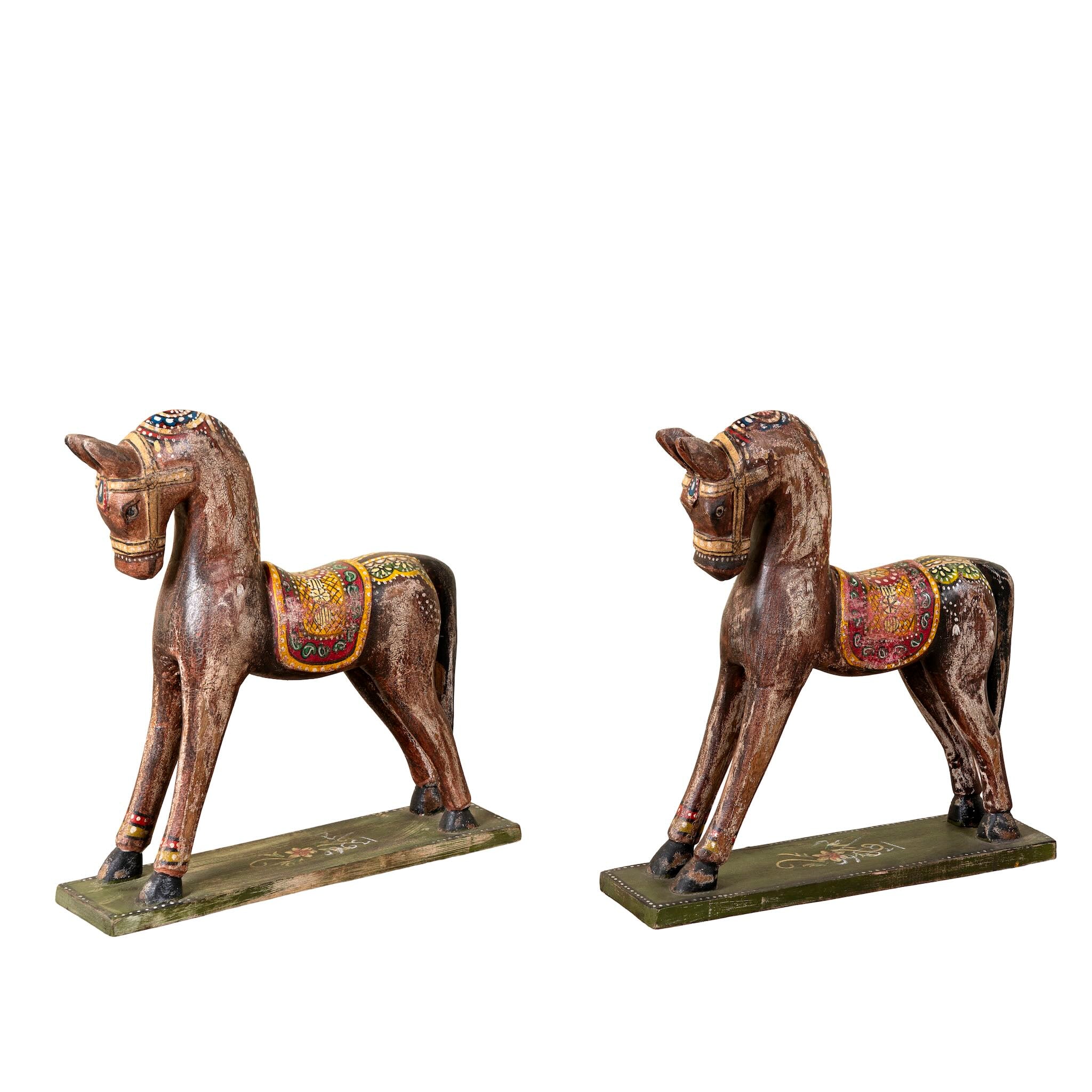 White background image of a hand-painted decorative wooden horse made from reclaimed wood with colourful saddle design – a vintage Indian home accessory full of character.