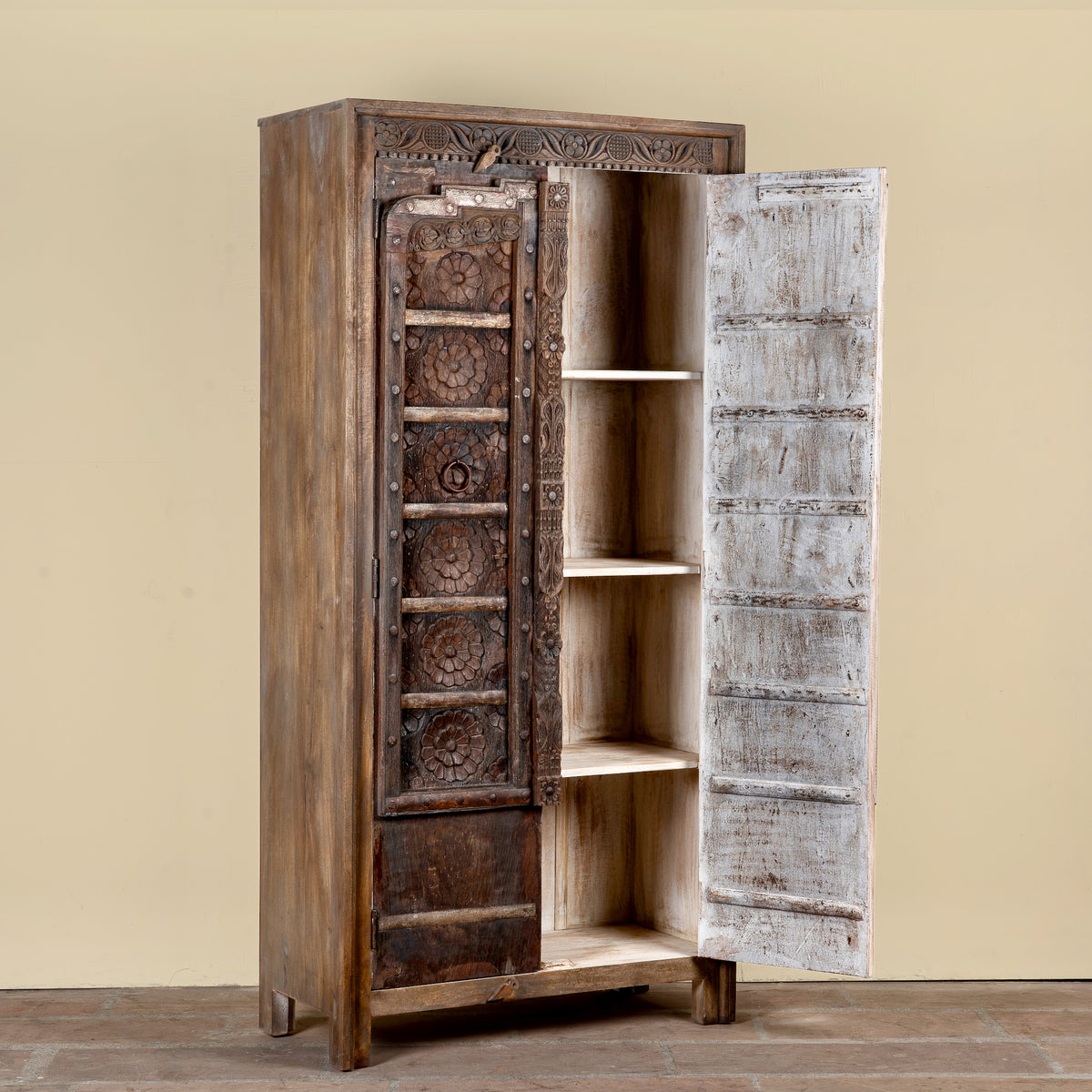 Open door image of a Srinika vintage Indian wardrobe with mango wood body and old hand-carved teak house door, 94x42x195cm