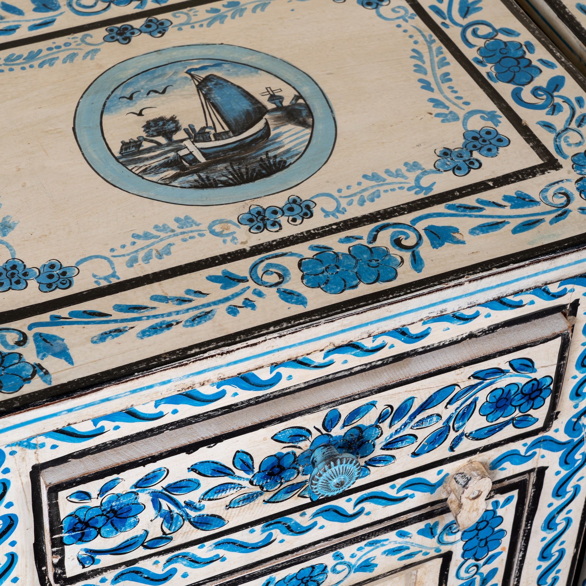 Close up image of a Suhasin limited edition reclaimed wood bedside table set with Delft inspired hand painted motifs