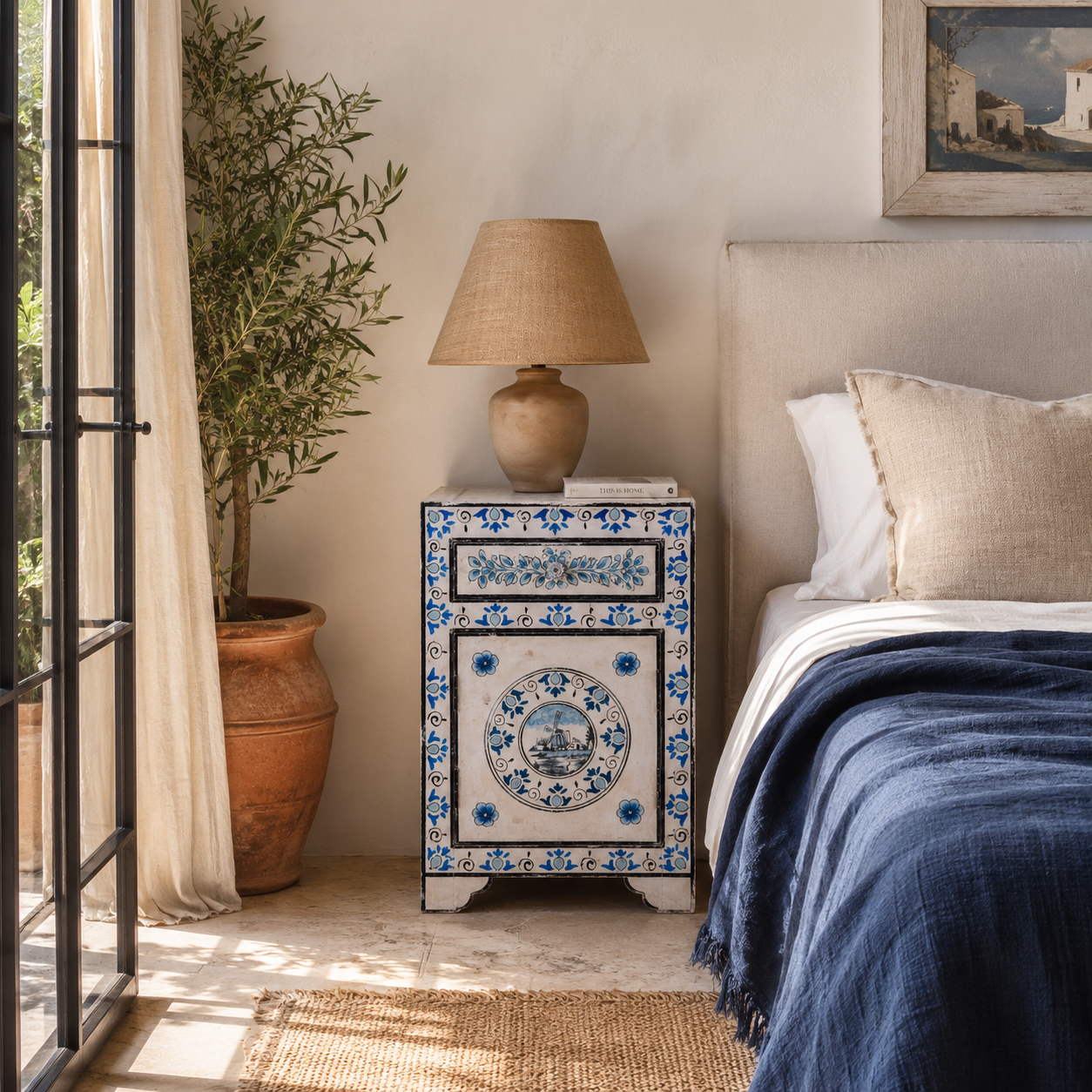 Lifestyle image of a Sunaina limited edition reclaimed wood bedside table set with Delft inspired hand painted motifs
