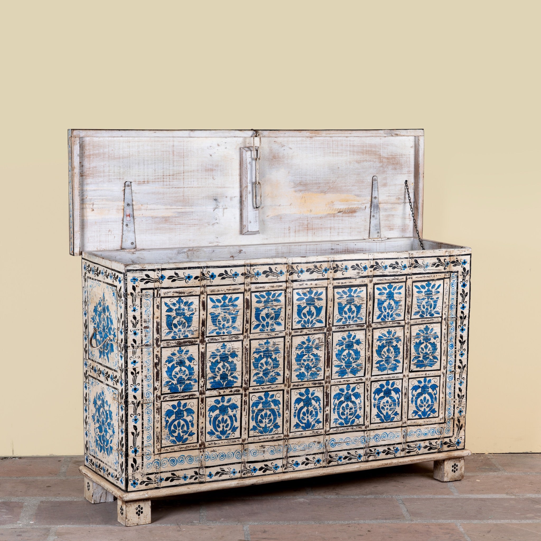 Side angle image with open lid of a Sur limited edition reclaimed wood storage chest with Delft inspired hand painted motifs