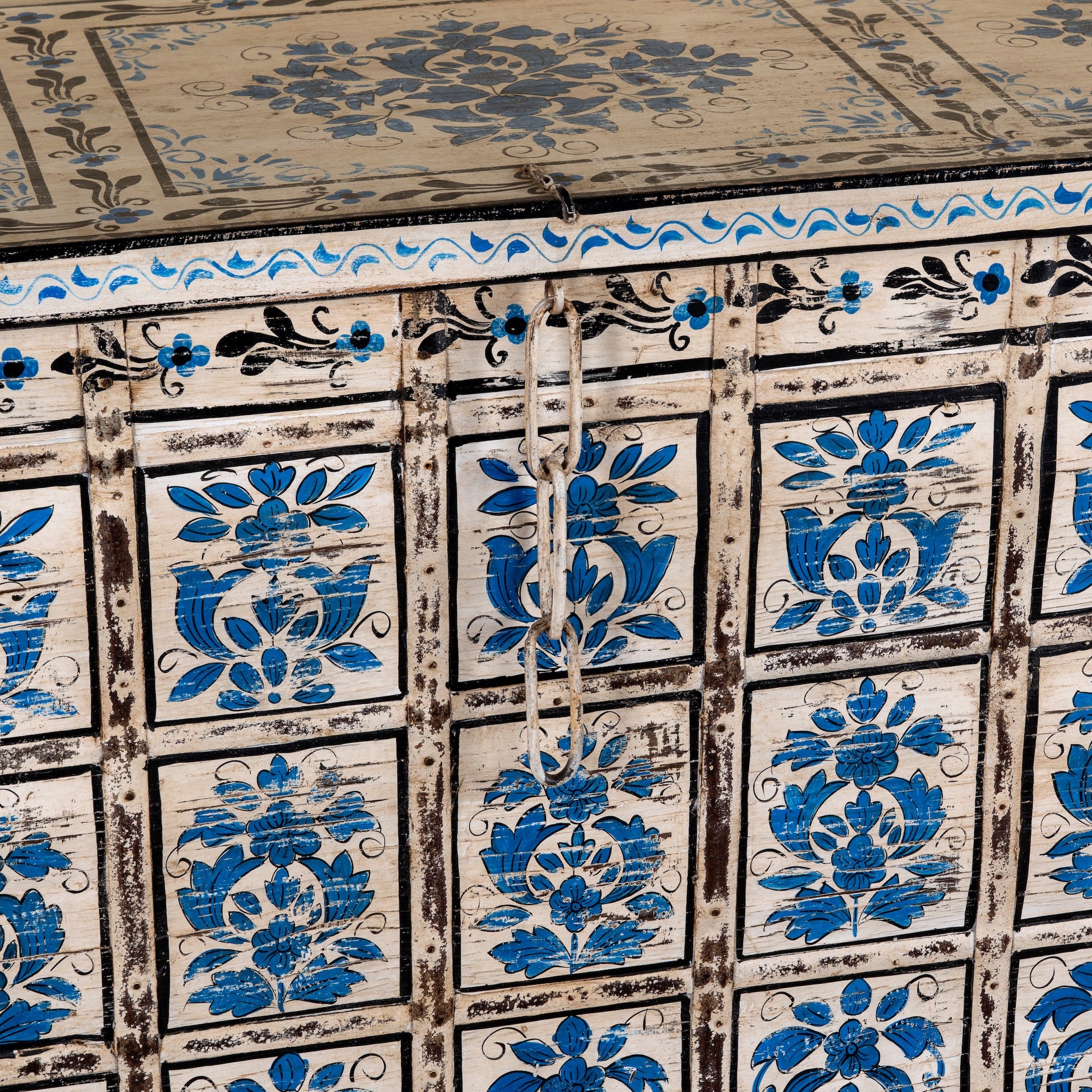 Close up image of a Sur limited edition reclaimed wood storage chest with Delft inspired hand painted motifs