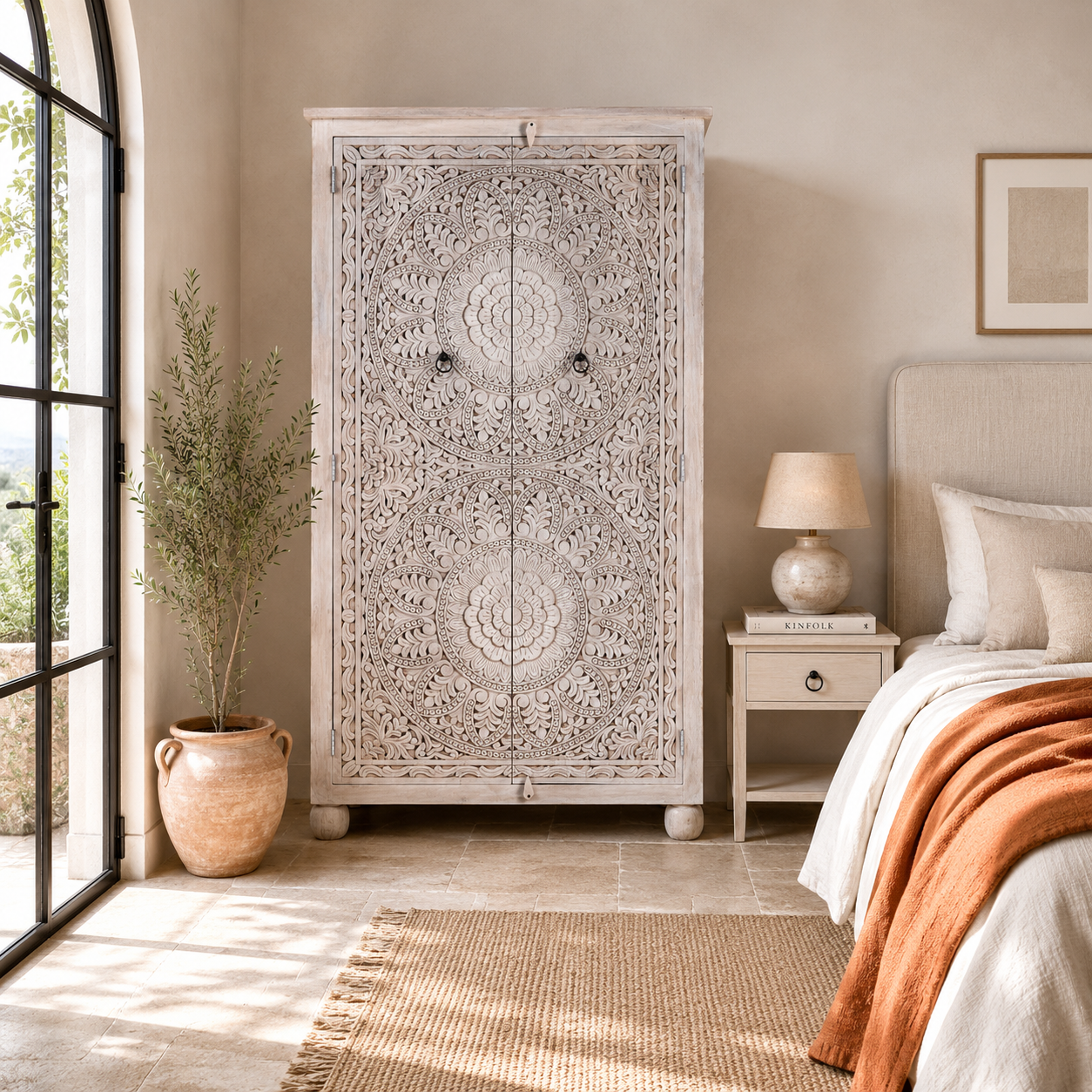 Lifestyle image of a Swara hand carved mango wood wardrobe in bleached Ibiza design with floral mandala doors, hanging rail and shelving, 110x56x190cm
