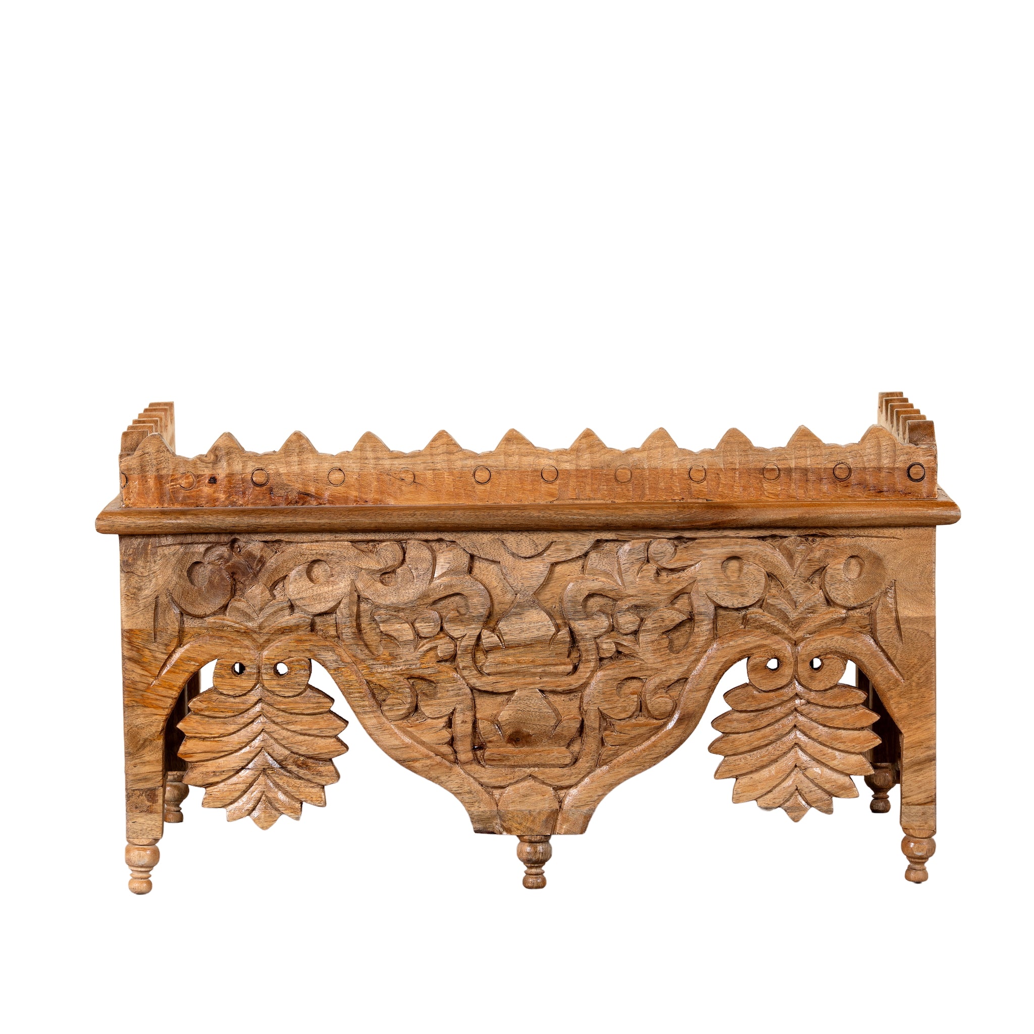 White background image of a Tanira hand carved mango wood wall shelf with floral carvings and decorative hanging leaf details 60cm