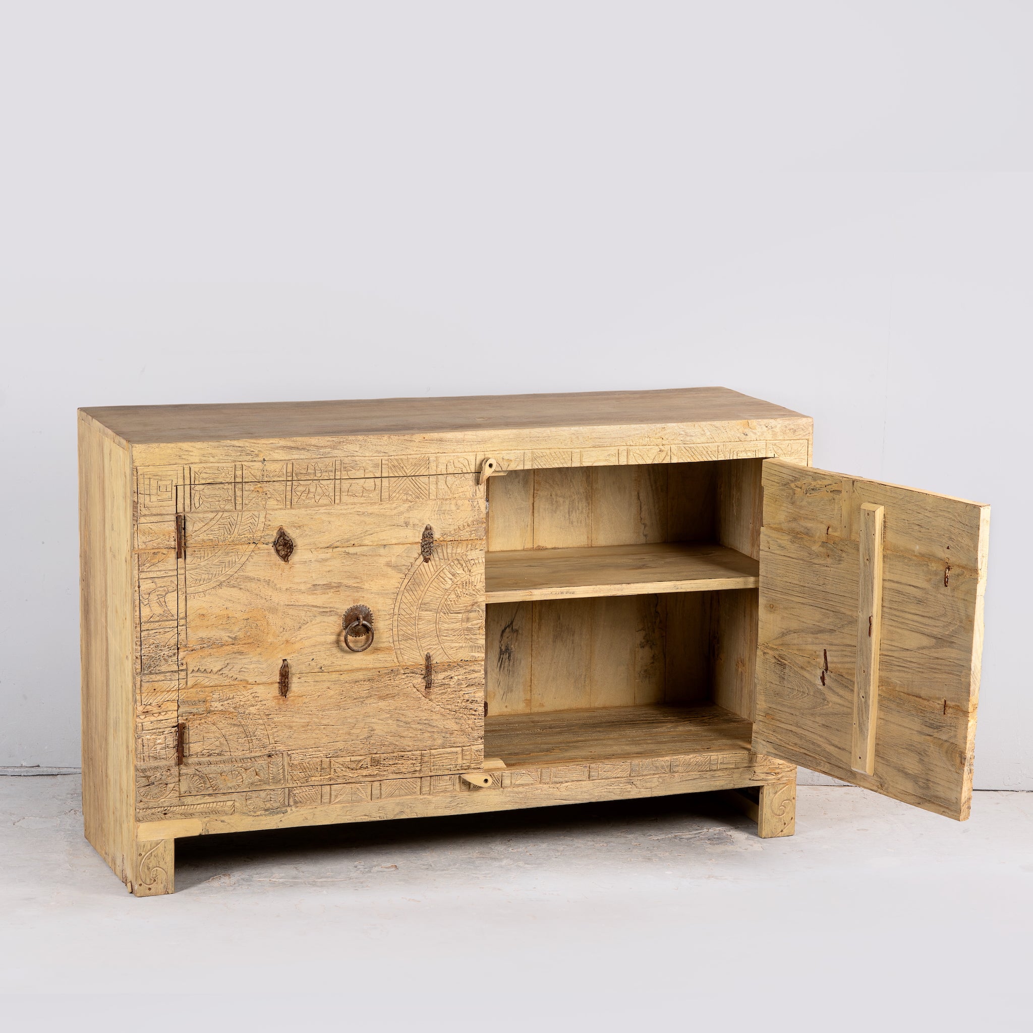 Side angle image with open door of a Tarini reclaimed teak wood sideboard with hand carved Orissa house door elements and original iron fittings 132cm