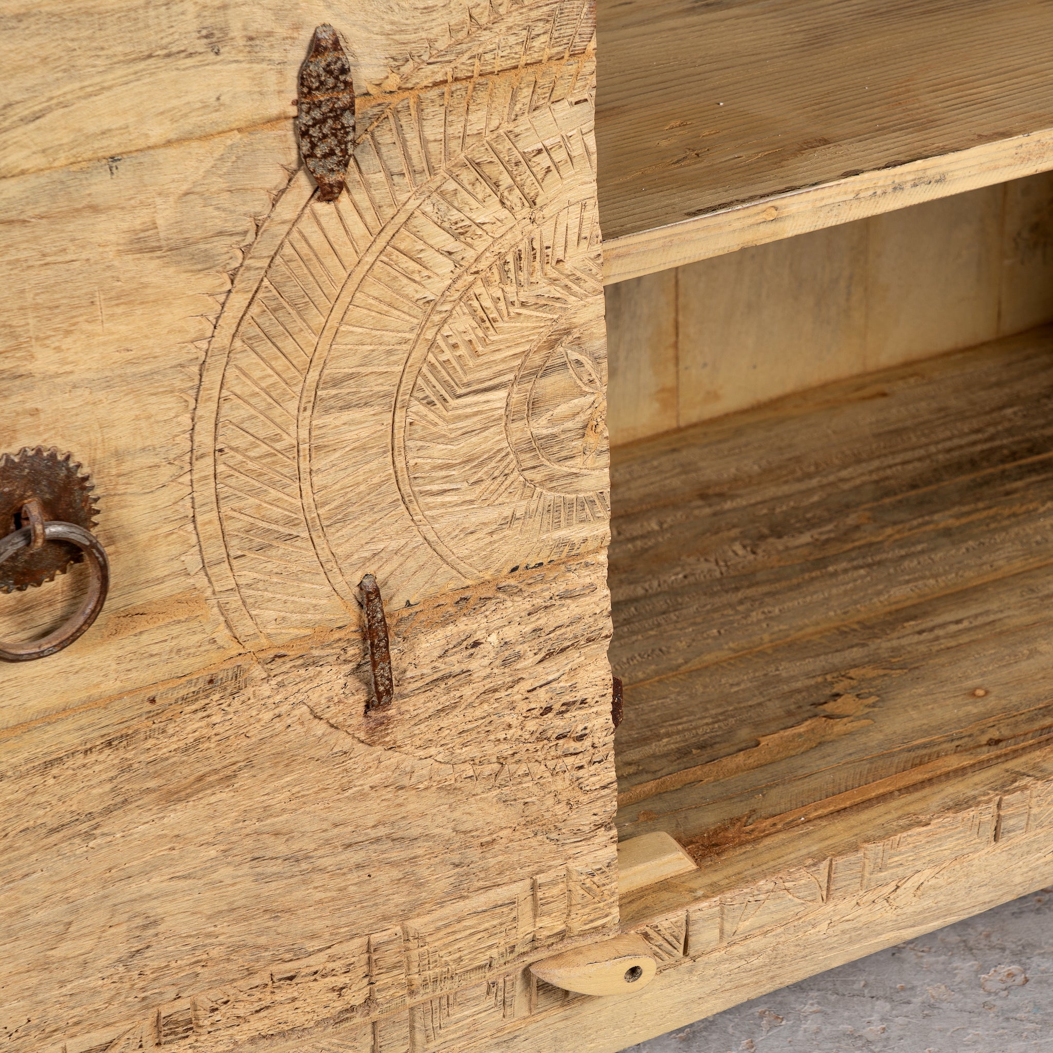 Close up image of the inner compartment of a Tarini reclaimed teak wood sideboard with hand carved Orissa house door elements and original iron fittings 132cm