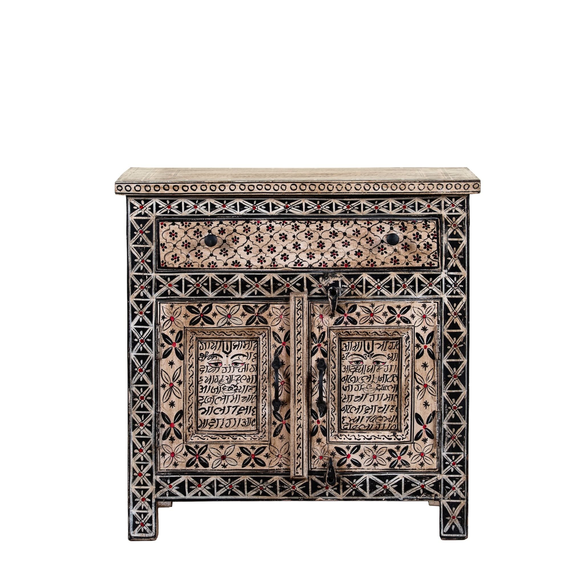 White background image of a hand painted bedside cabinet made of reclaimed wood with one drawer and two doors in Sanskrit style.