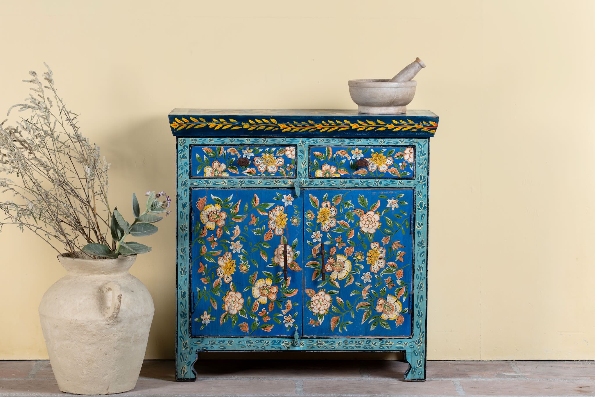 Hand-painted cupboard made of reclaimed wood with vibrant floral design – Tvesa model by Om Home & Garden